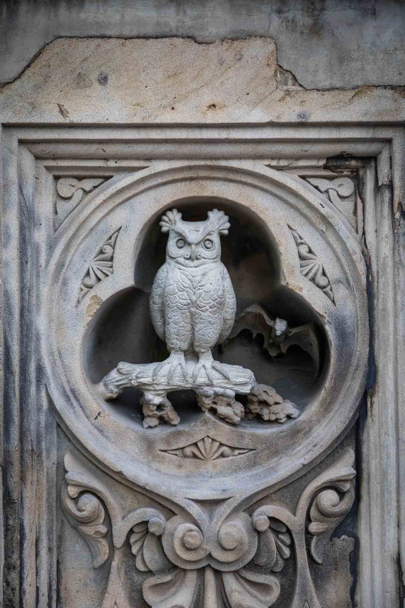 Stone carving of owl on bridge in Central Park