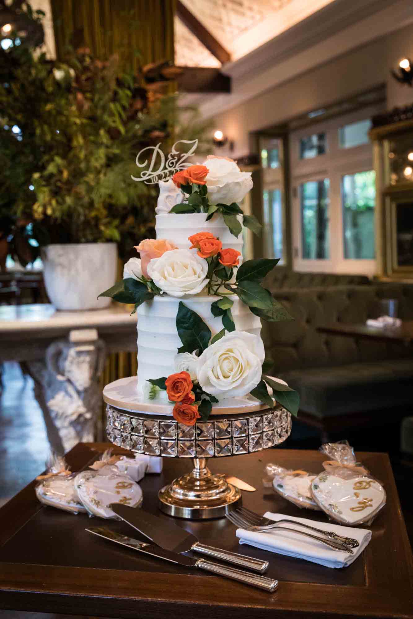 Wedding cake on stand covered in flowers