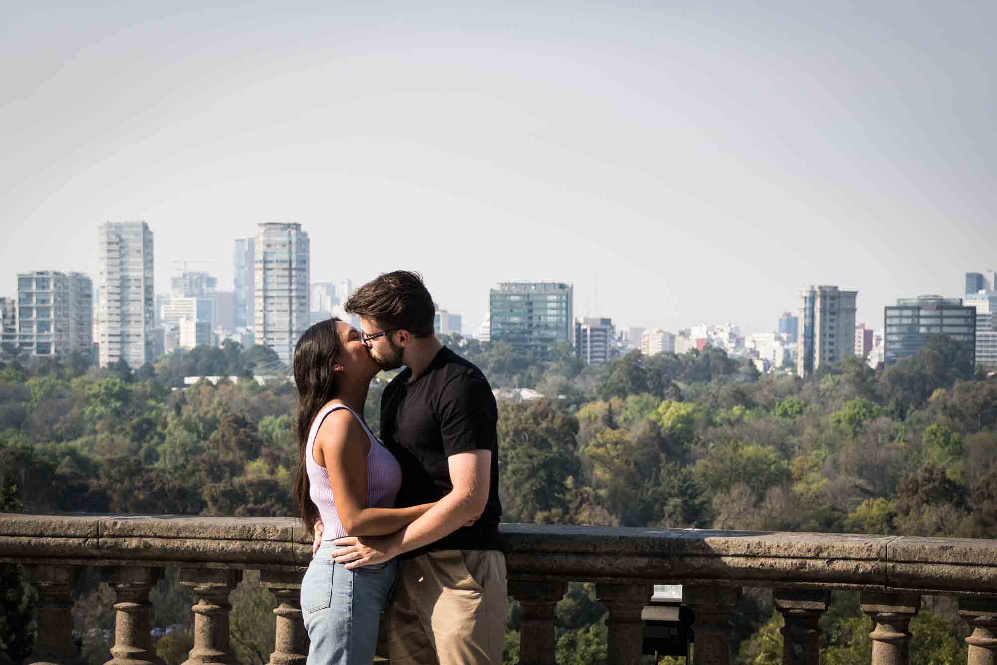 A couple kisses on the terrace overlooking Mexico City at Chapultepec Castle