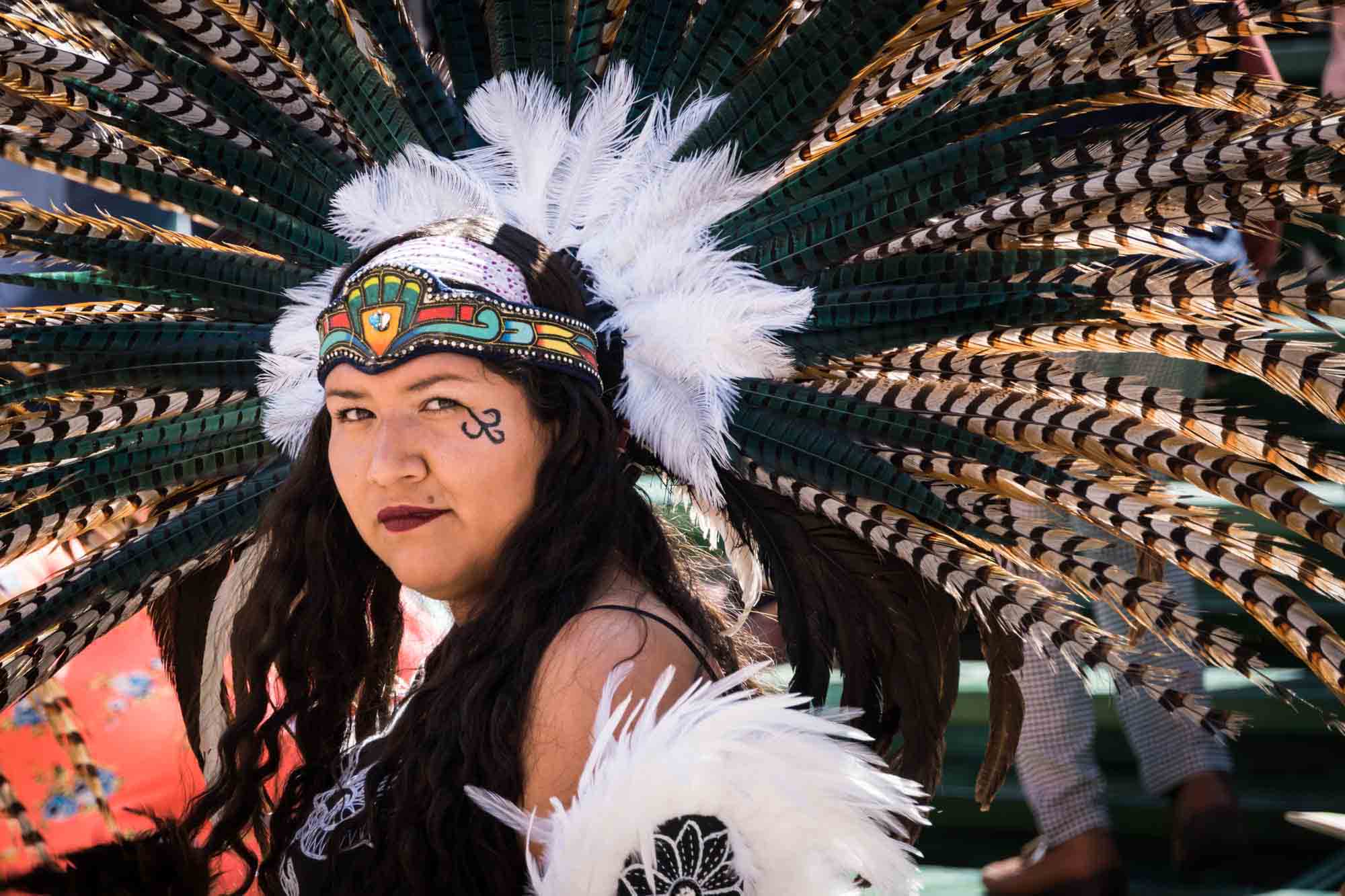 An indigenous wearing a brightly colored, feather costume dances in Guanajuato