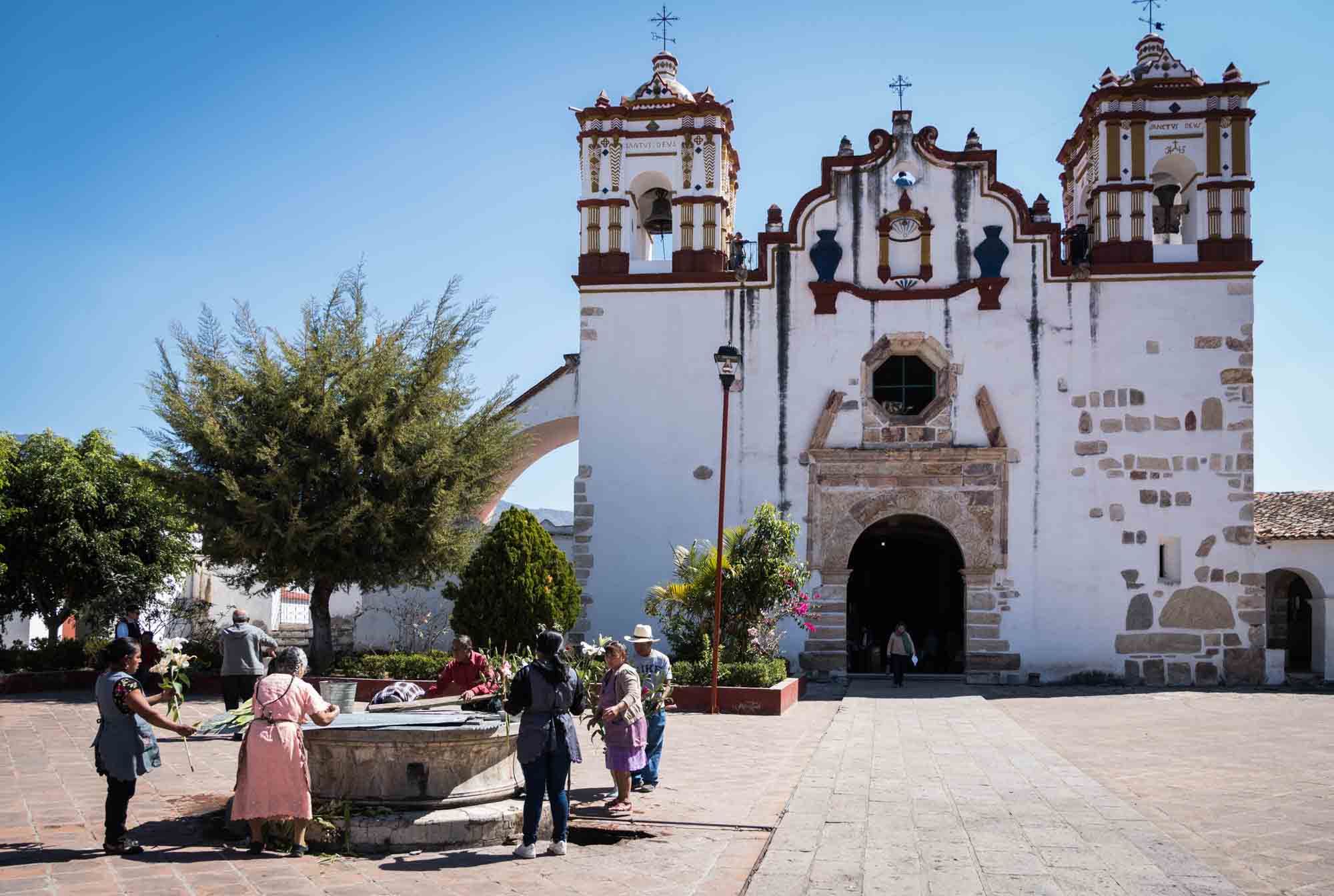 People preparing flowers outside a church in Teotitlan del Valle