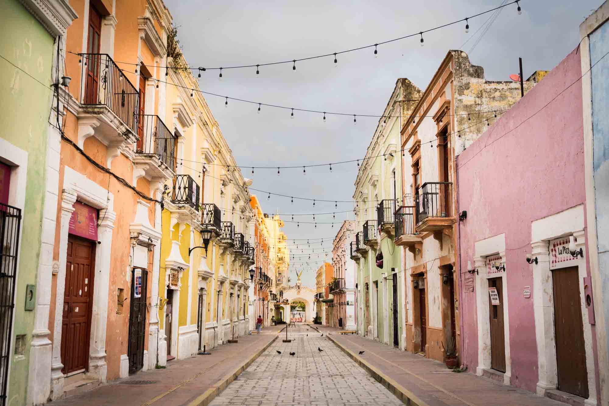 Colorful building fronts down a street in Campeche.