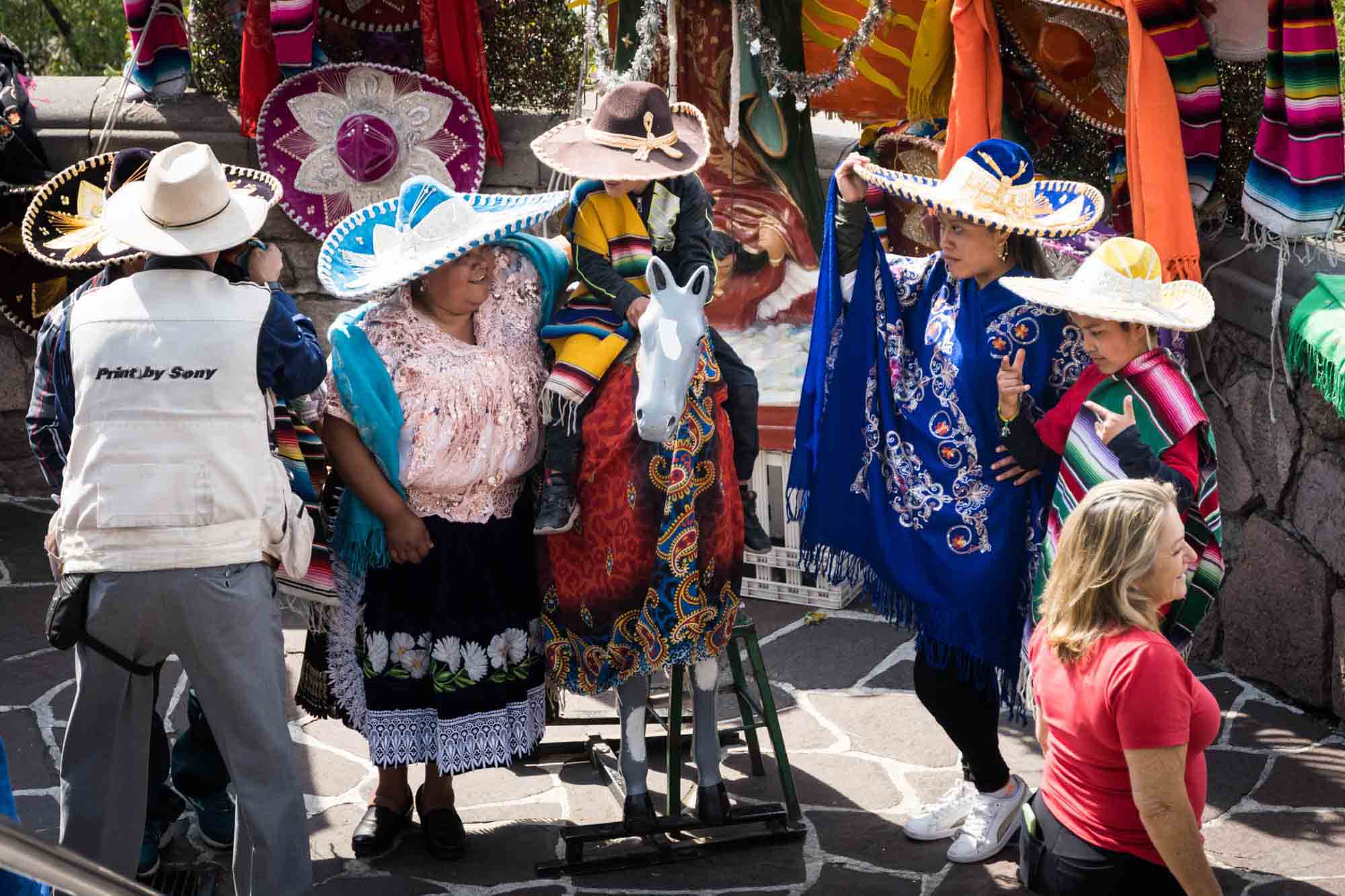 A family dressed in sombreros and traditional Mexican outfits for a photo session outside the Basilica of Our Lady Guadalupe in Mexico City