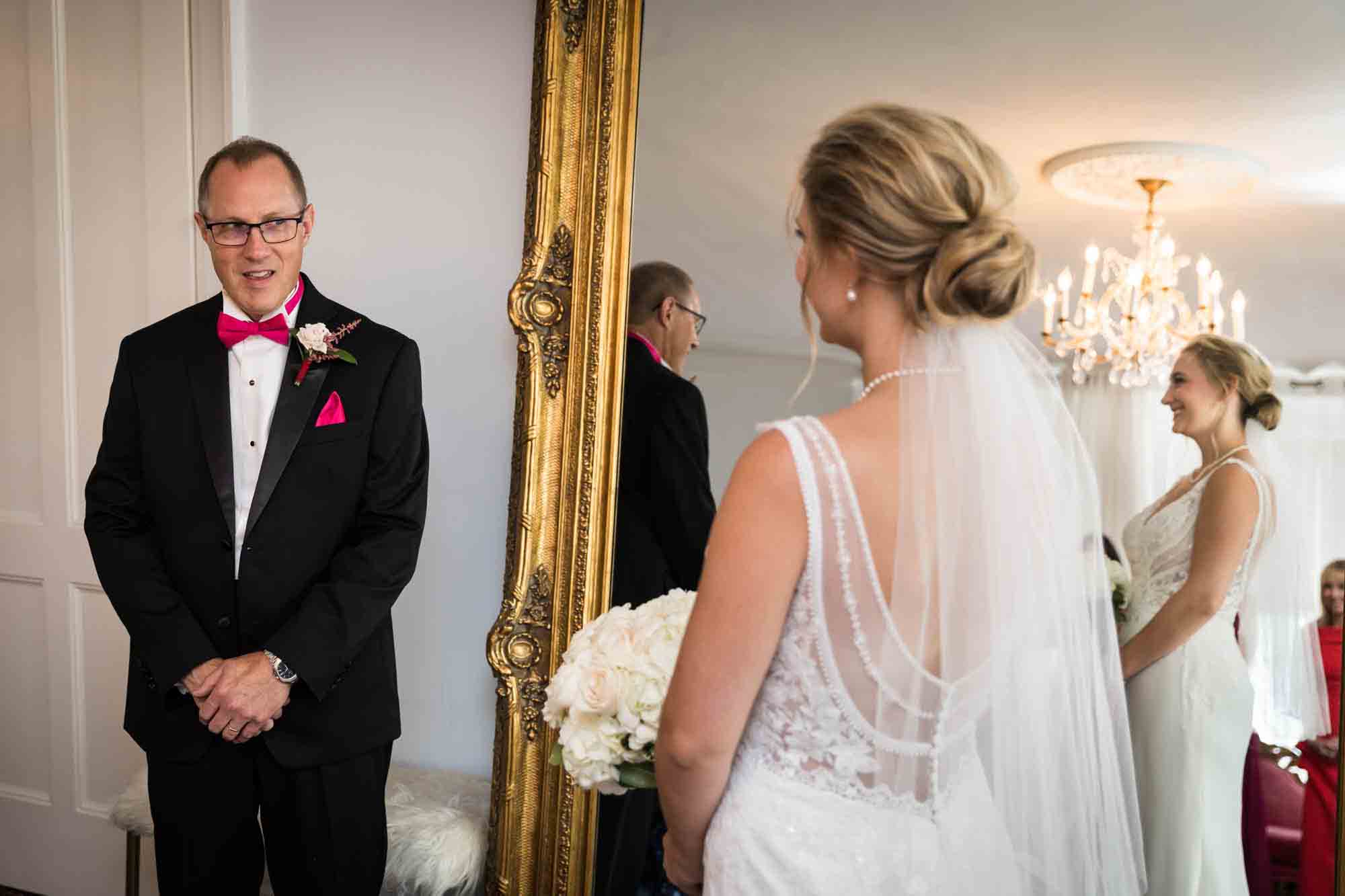 Father seeing bride in wedding dress for the first time in front of vintage mirror at a Briarcliff Manor wedding