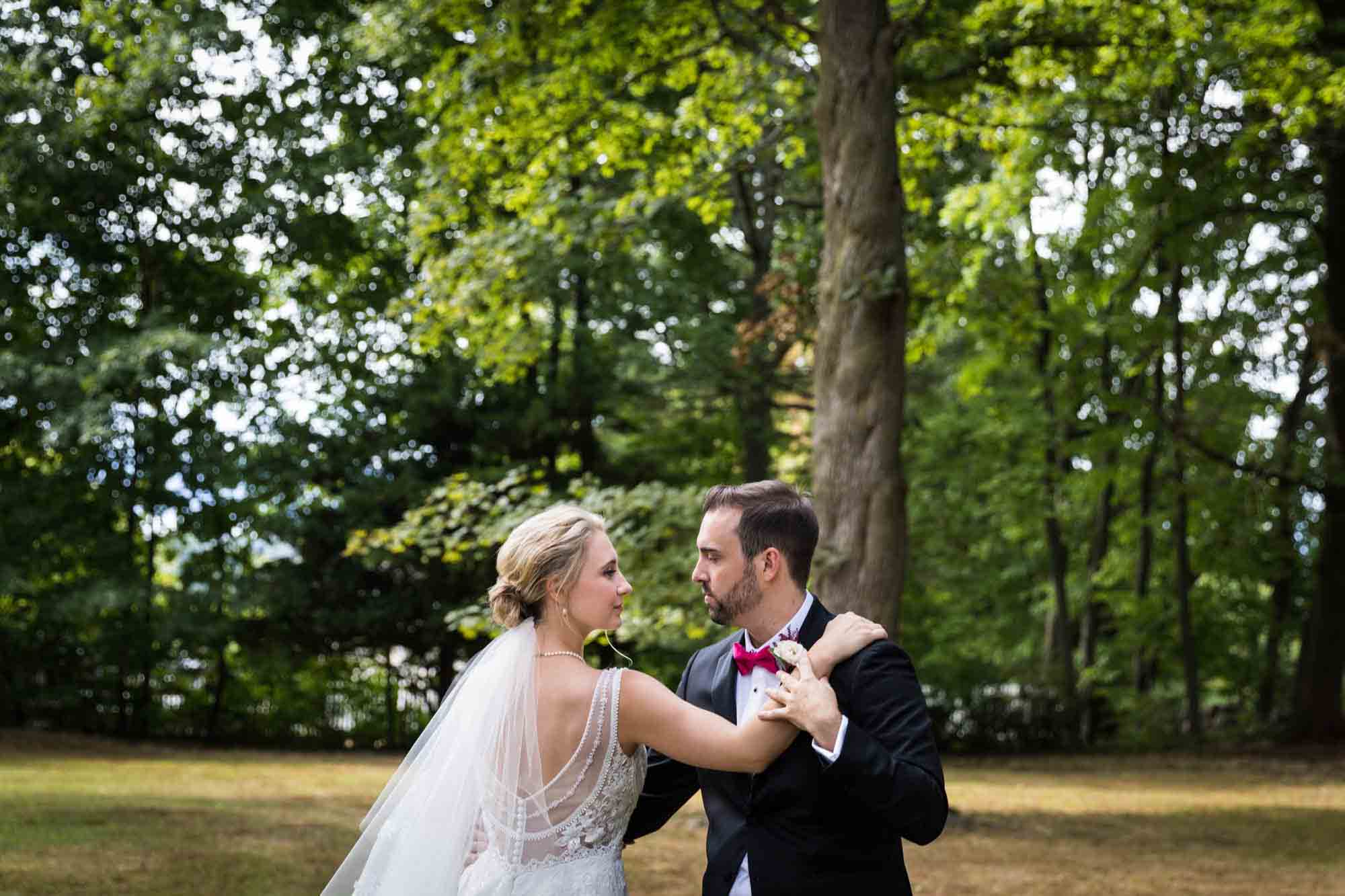 Bride and groom dancing outside in front of trees at a Briarcliff Manor wedding