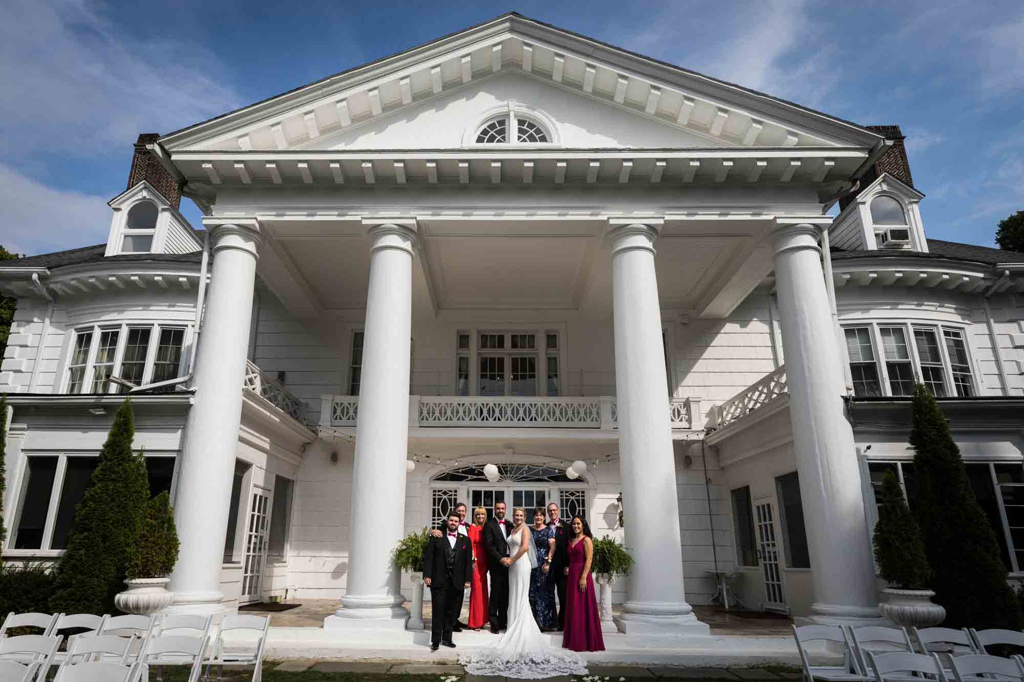 Bridal party on steps of white historical home with Greek columns at a Briarcliff Manor wedding