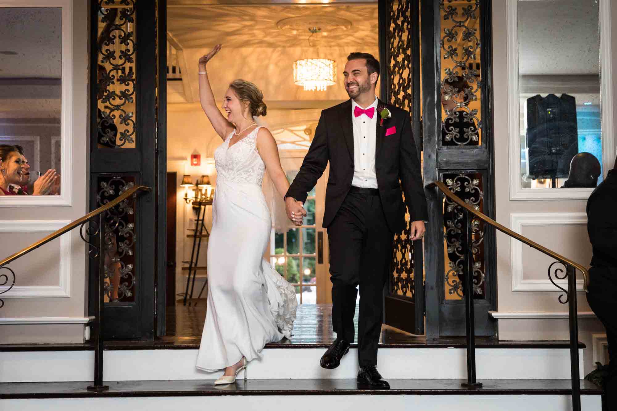 Bride and groom walking down steps and greeting guests at at a Briarcliff Manor wedding reception