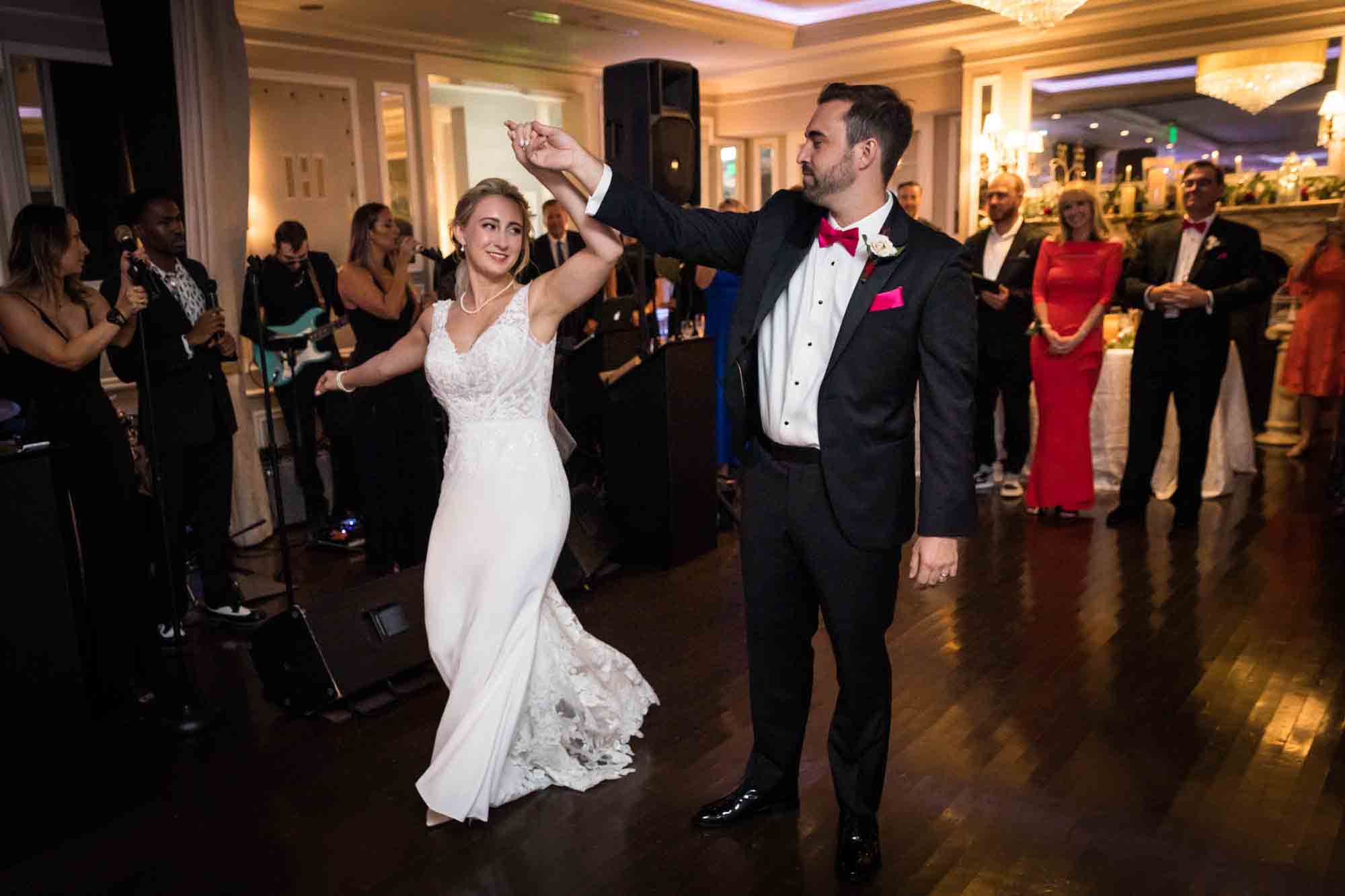 Groom leading bride on to the dance floor for first dance at a Briarcliff Manor wedding
