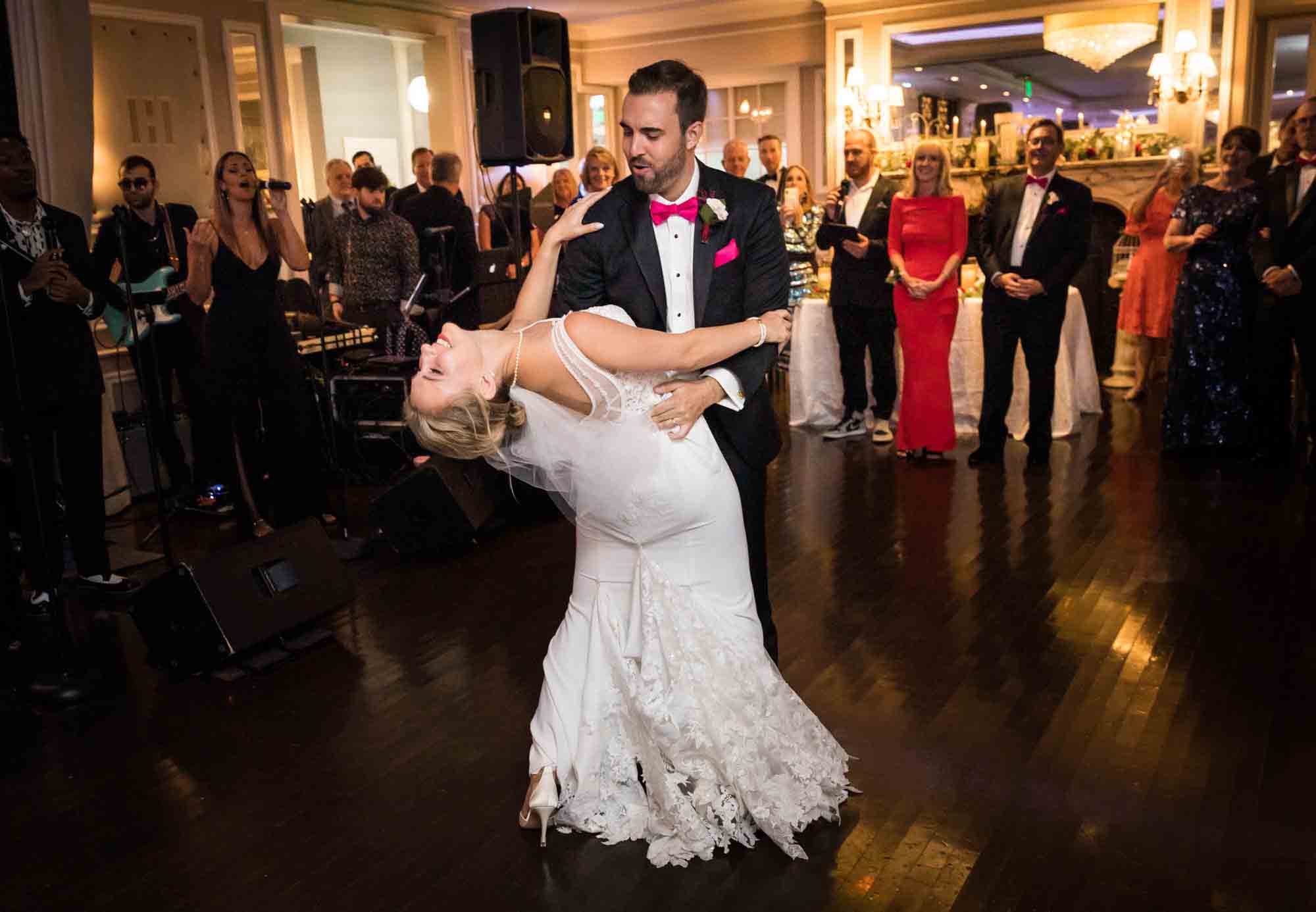 Groom leading bride into a dip on dance floor at a Briarcliff Manor wedding