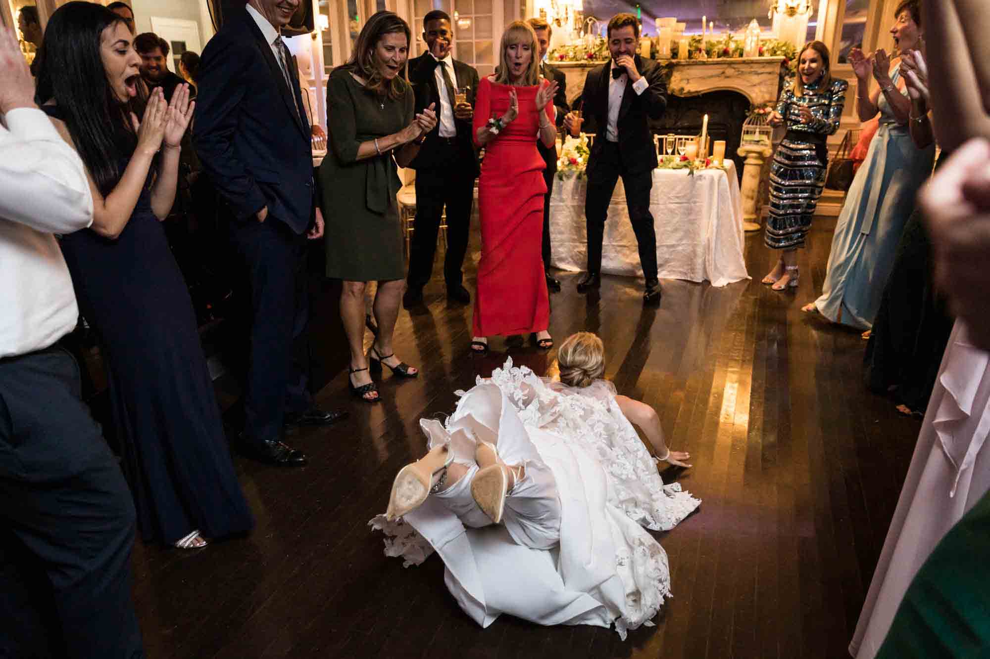 Bride dancing on the floor with guests reacing at a Briarcliff Manor wedding