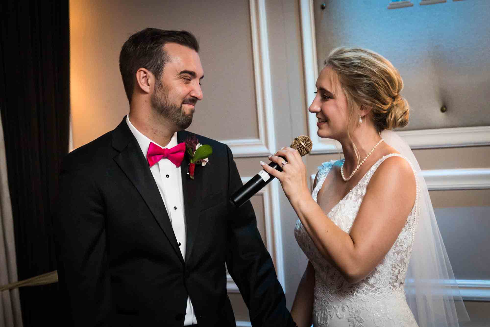 Bride singing to the groom and holding microphone at a Briarcliff Manor wedding