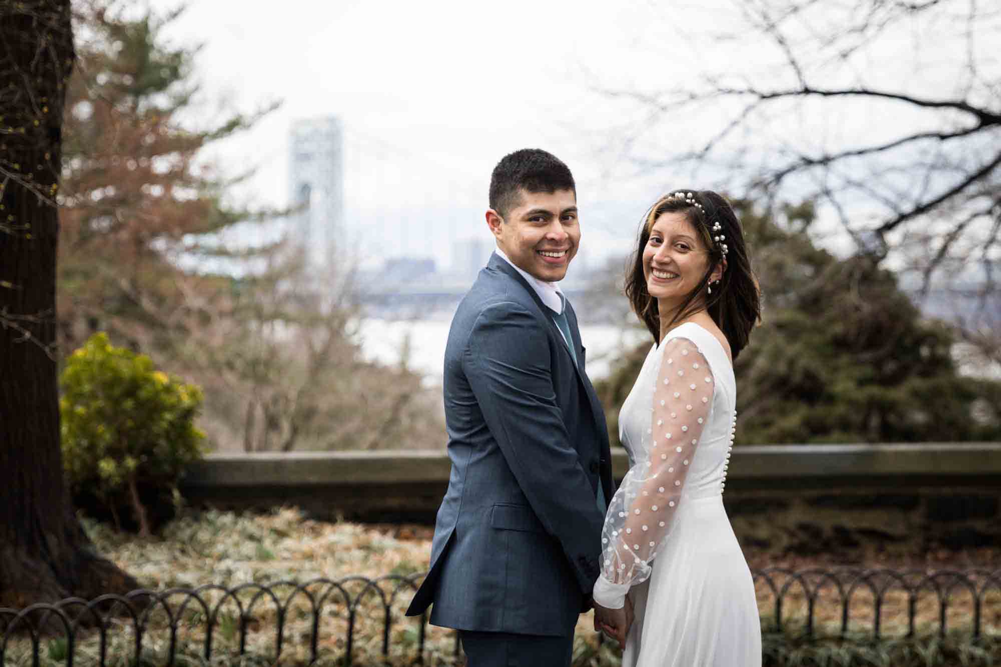 A bride and groom holding hands during a Fort Tryon Park wedding