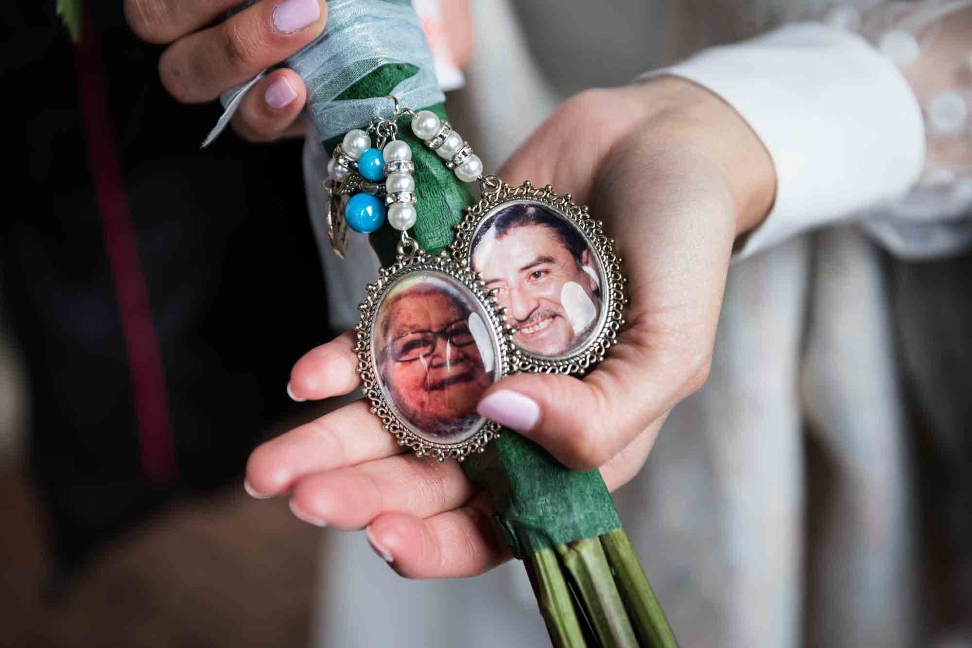 Close up of bride showing bouquet with lockets containing photos of loved ones