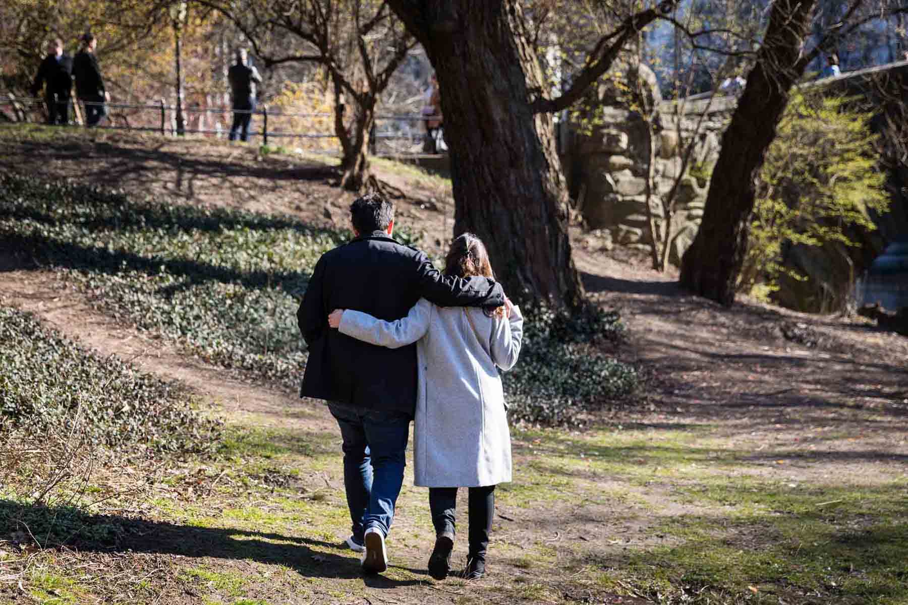 Couple walking with arms around each other in Central Park