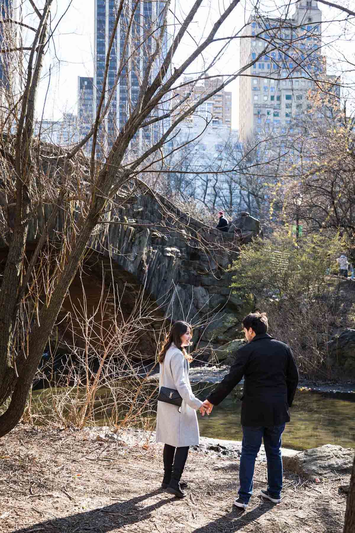 Couple in front of bridge during a Gapstow Bridge surprise proposal in Central Park