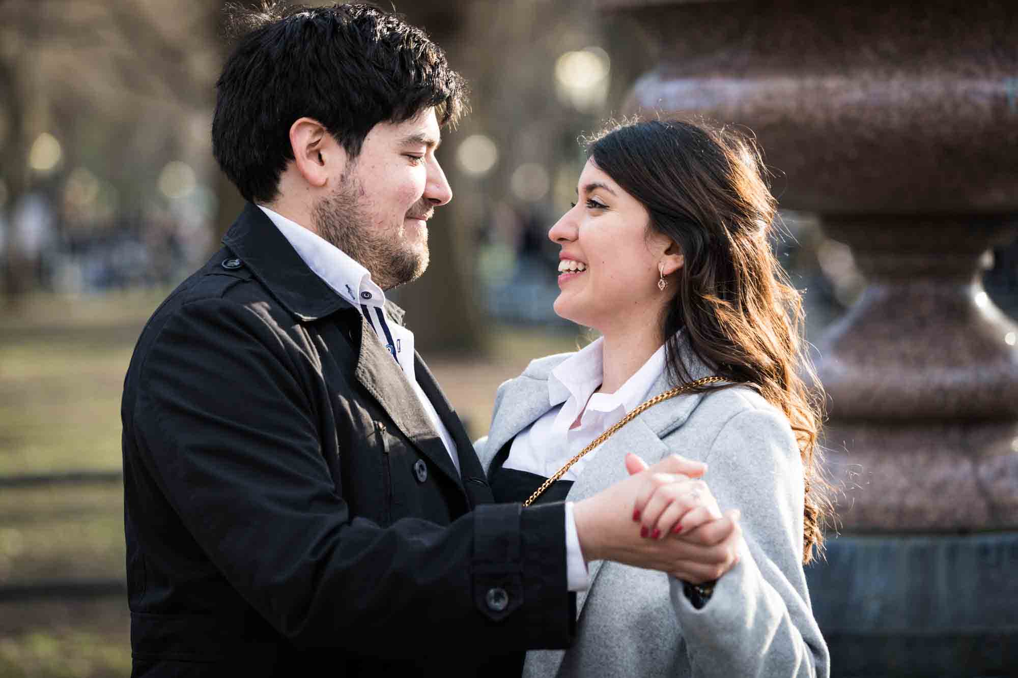 Couple dancing in park during a Central Park surprise proposal