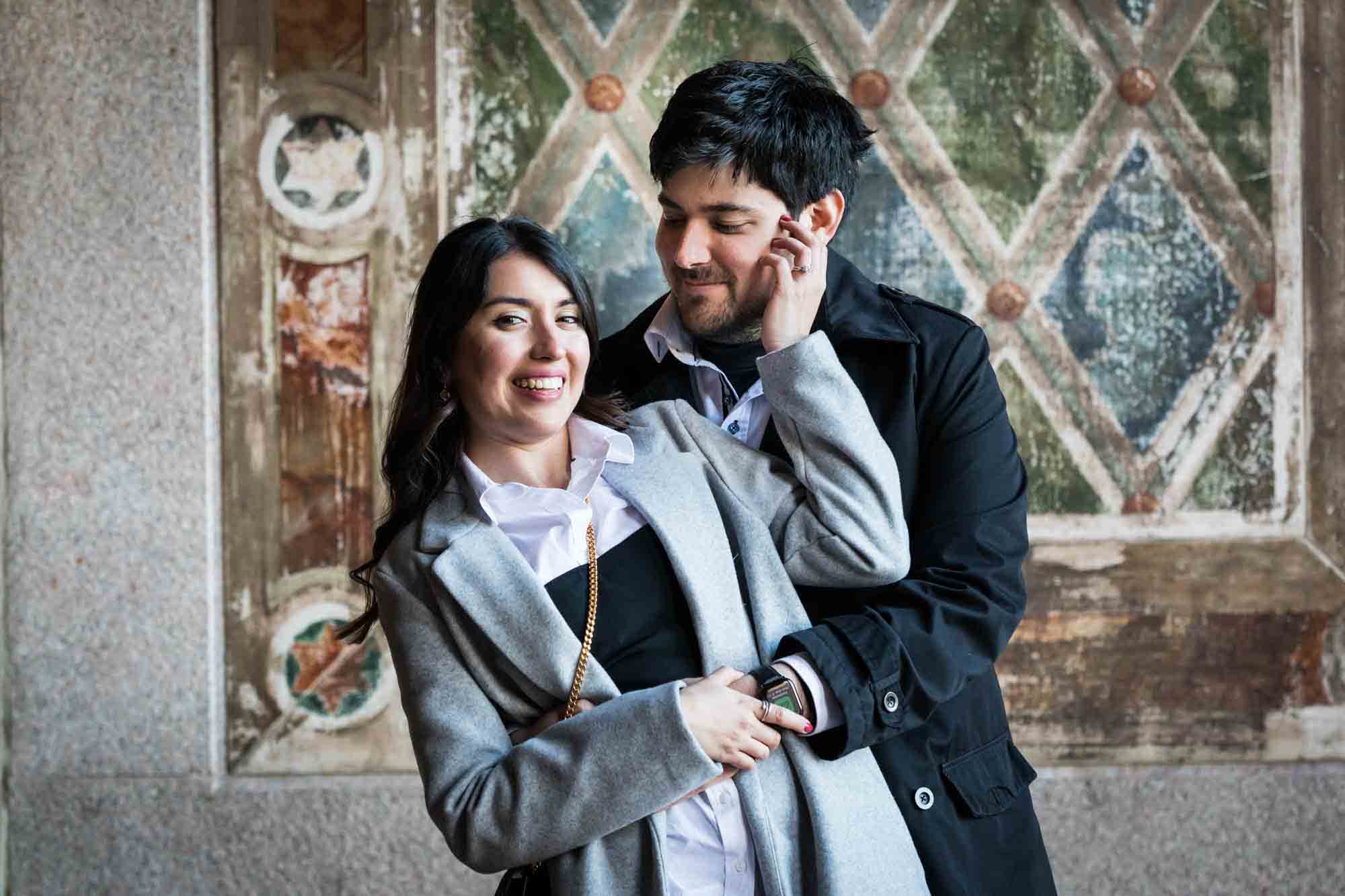 Woman touching man's face under Bethesda Terrace after a NYC surprise proposal