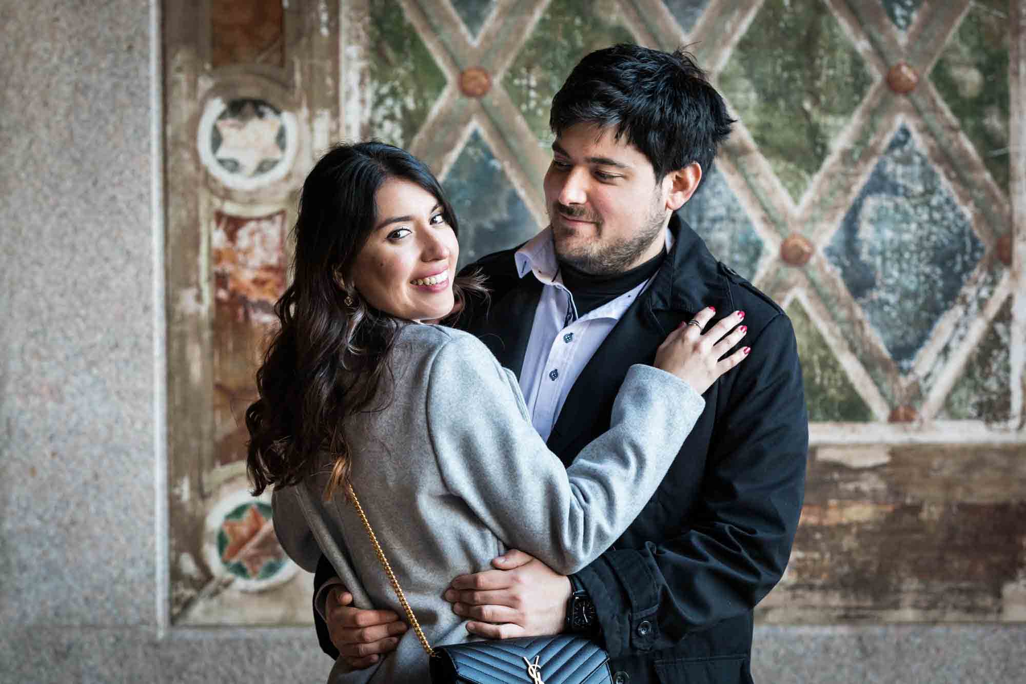 Couple hugging under Bethesda Terrace after a NYC surprise proposal