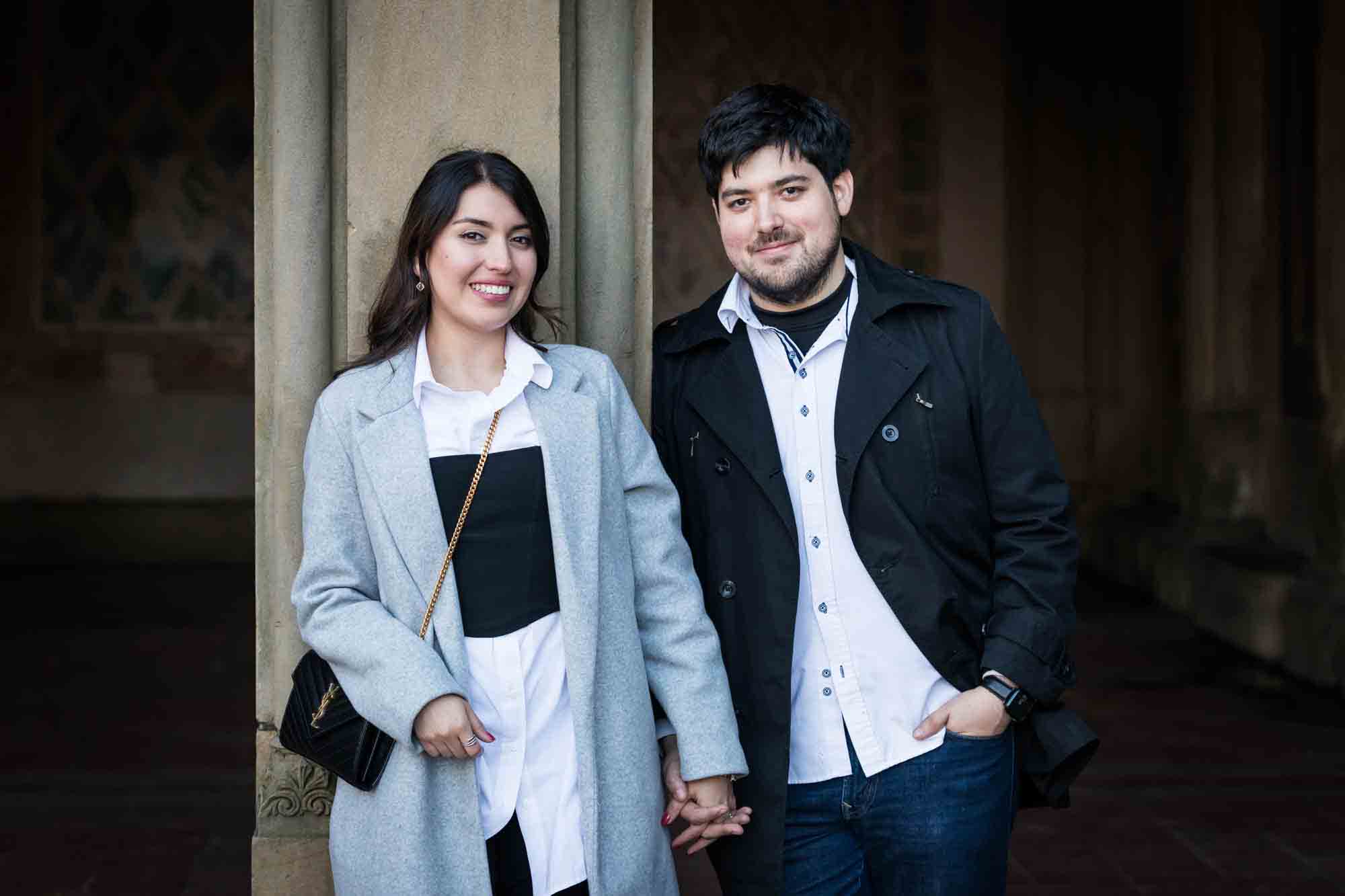 Couple holding hands in front of Bethesda Terrace after a NYC surprise proposal