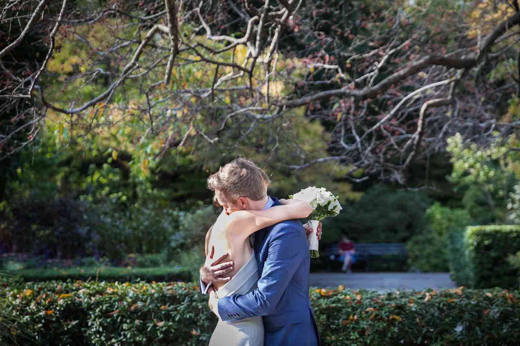 Conservatory Garden wedding photos of bride and groom hugging in garden