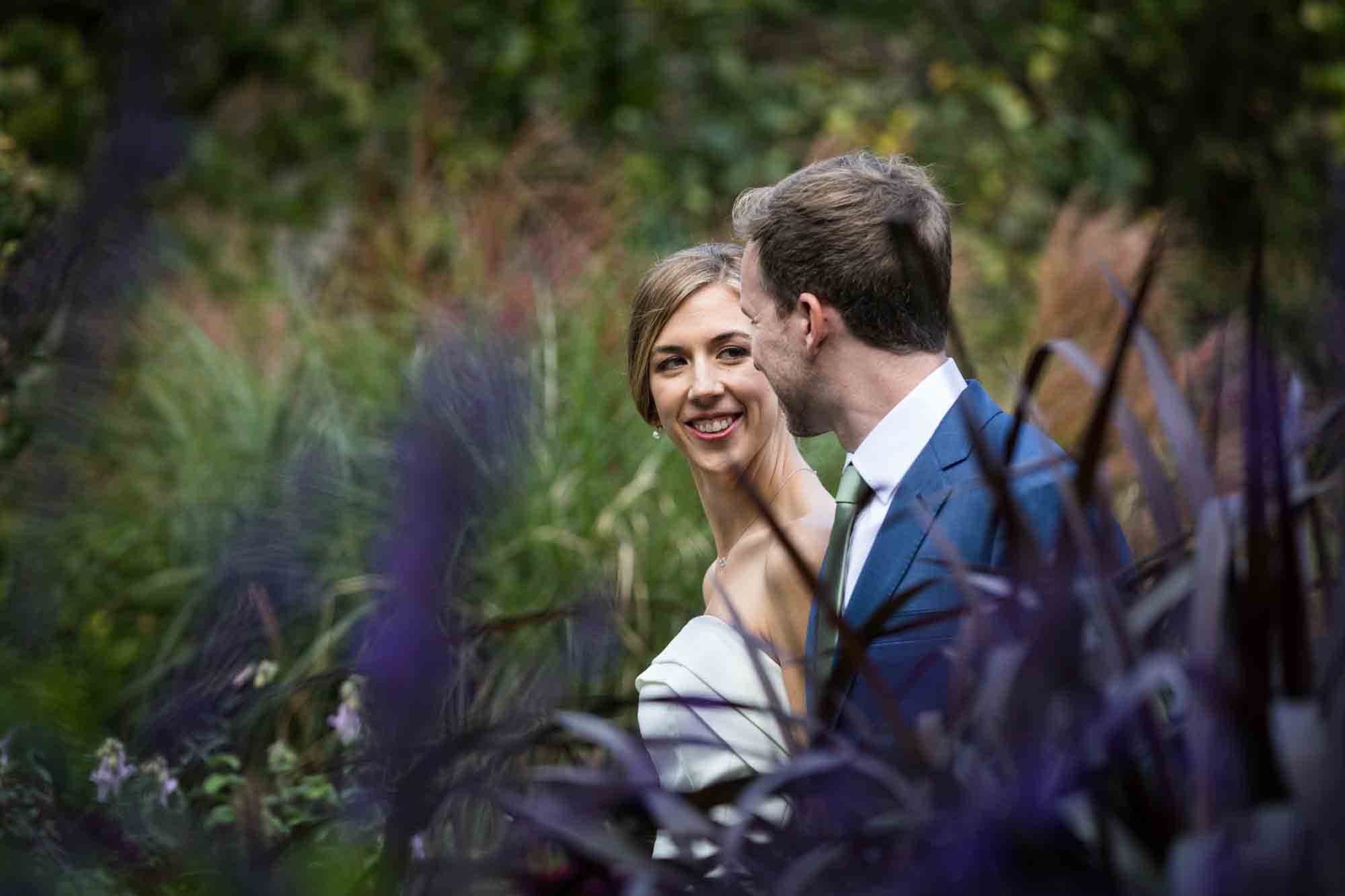 Conservatory Garden wedding photos of bride and groom walking through garden