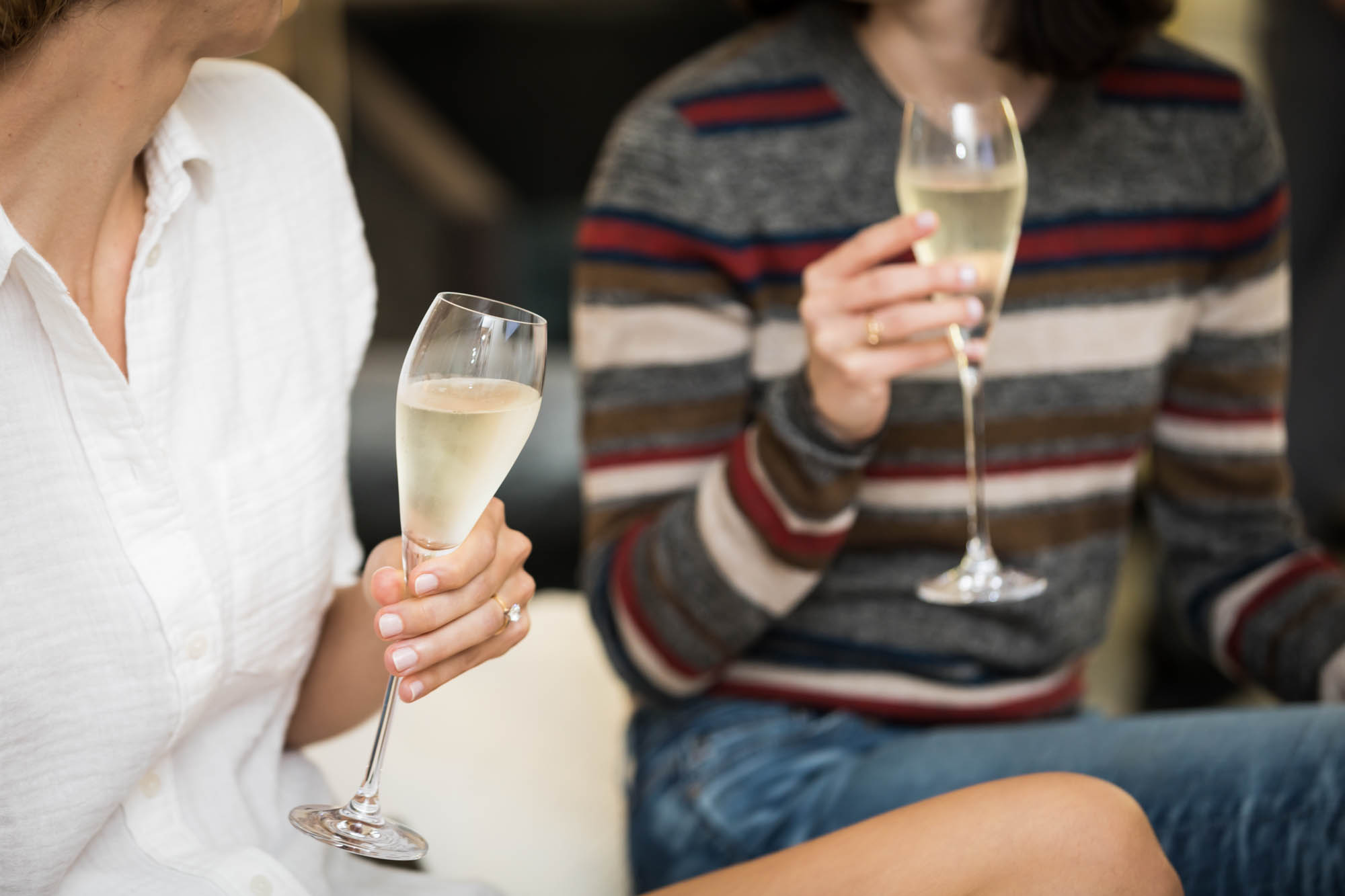 Close up of two woman holding glasses of champagne