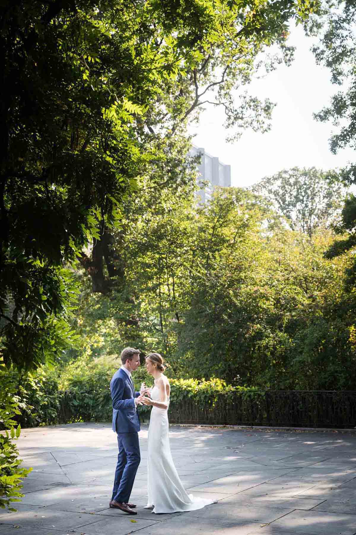 Couple dancing on patio outside Wisteria Terrace during a Conservatory Garden wedding in Central Park