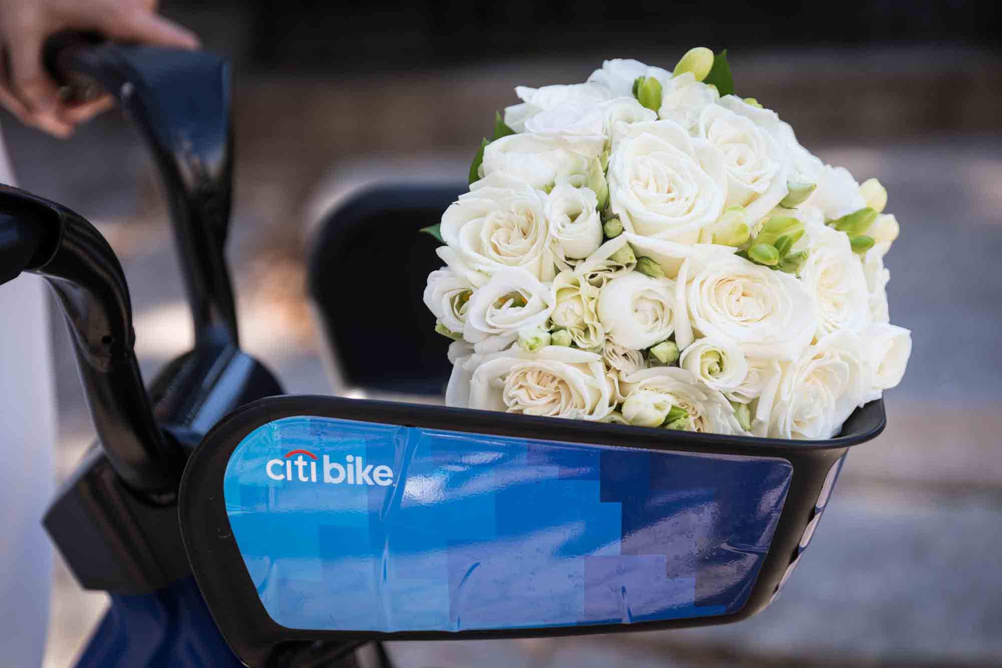White flower bouquet in basket of Citi Bike