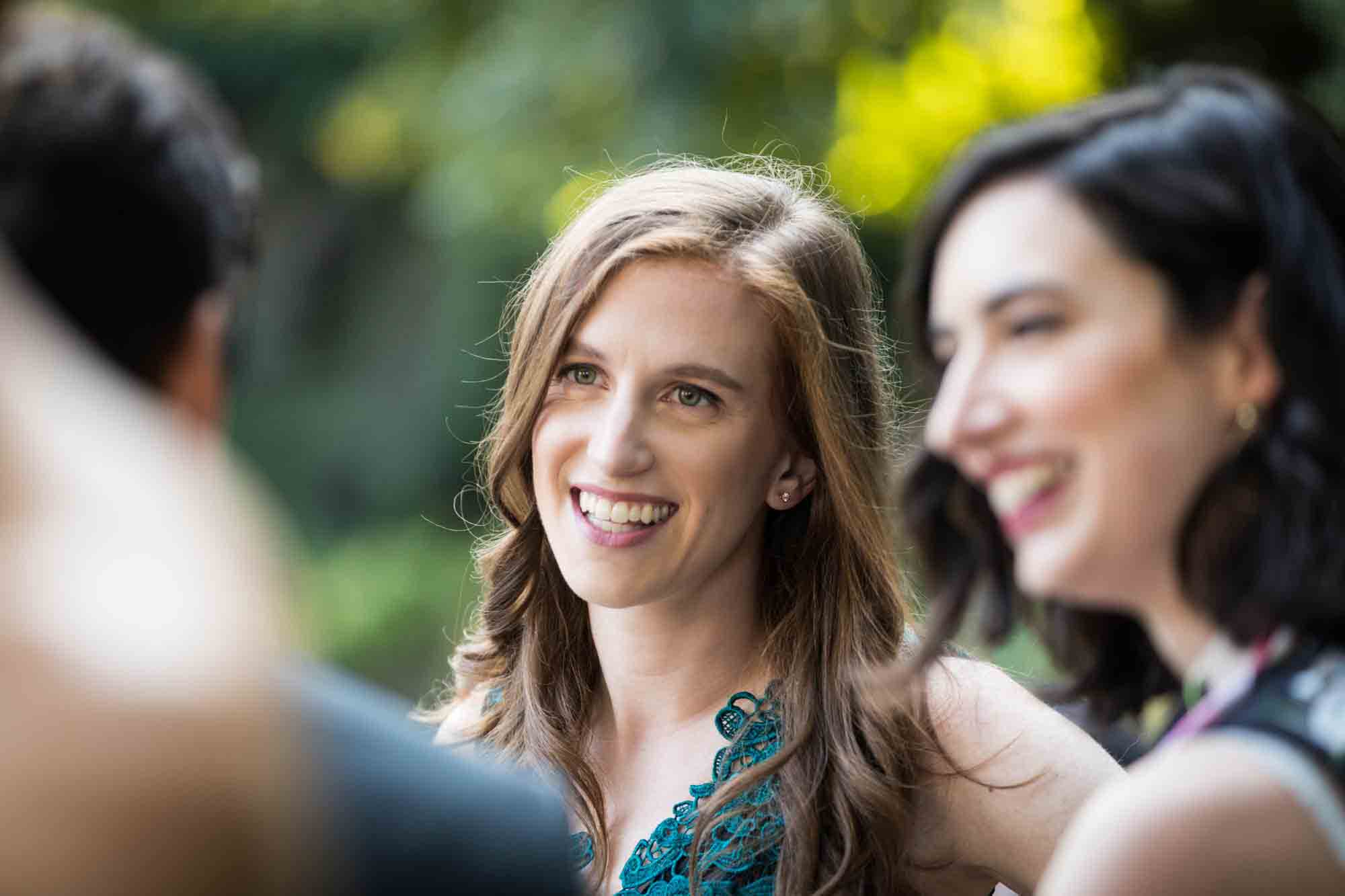 Female guests smiling during a Conservatory Garden wedding in Central Park