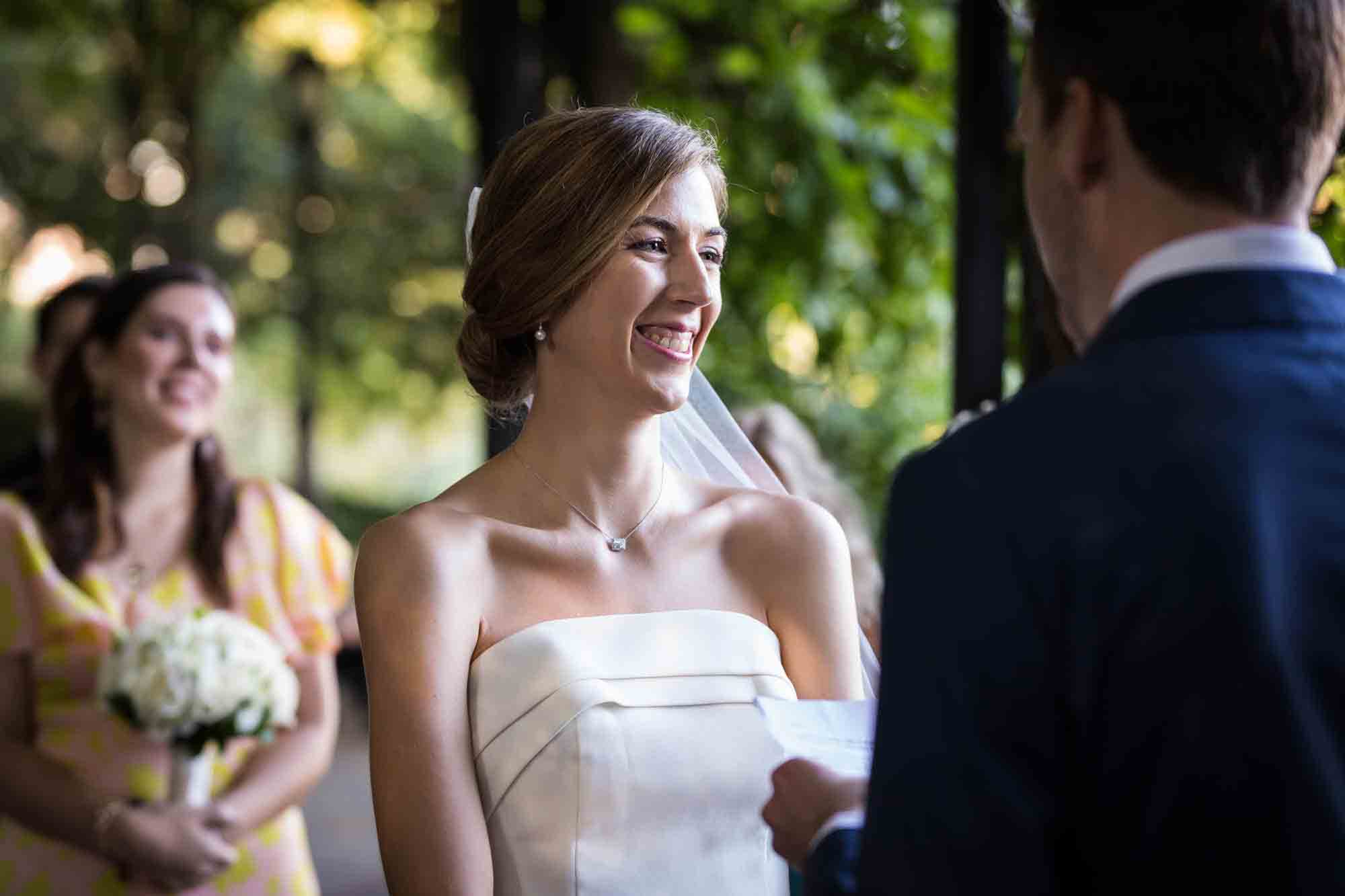 Bride laughing during ceremony during a Conservatory Garden wedding in Central Park