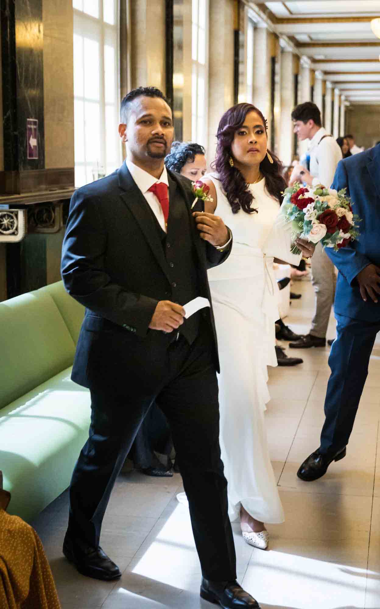 Couple walking in City Clerk's Office waiting area at a NYC City Hall wedding