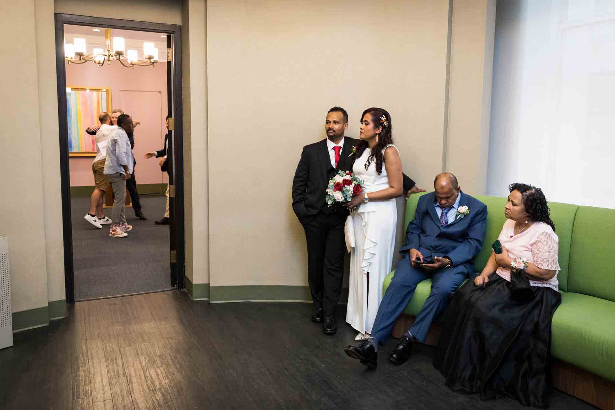 Couple and family waiting outside door  at a NYC City Hall wedding