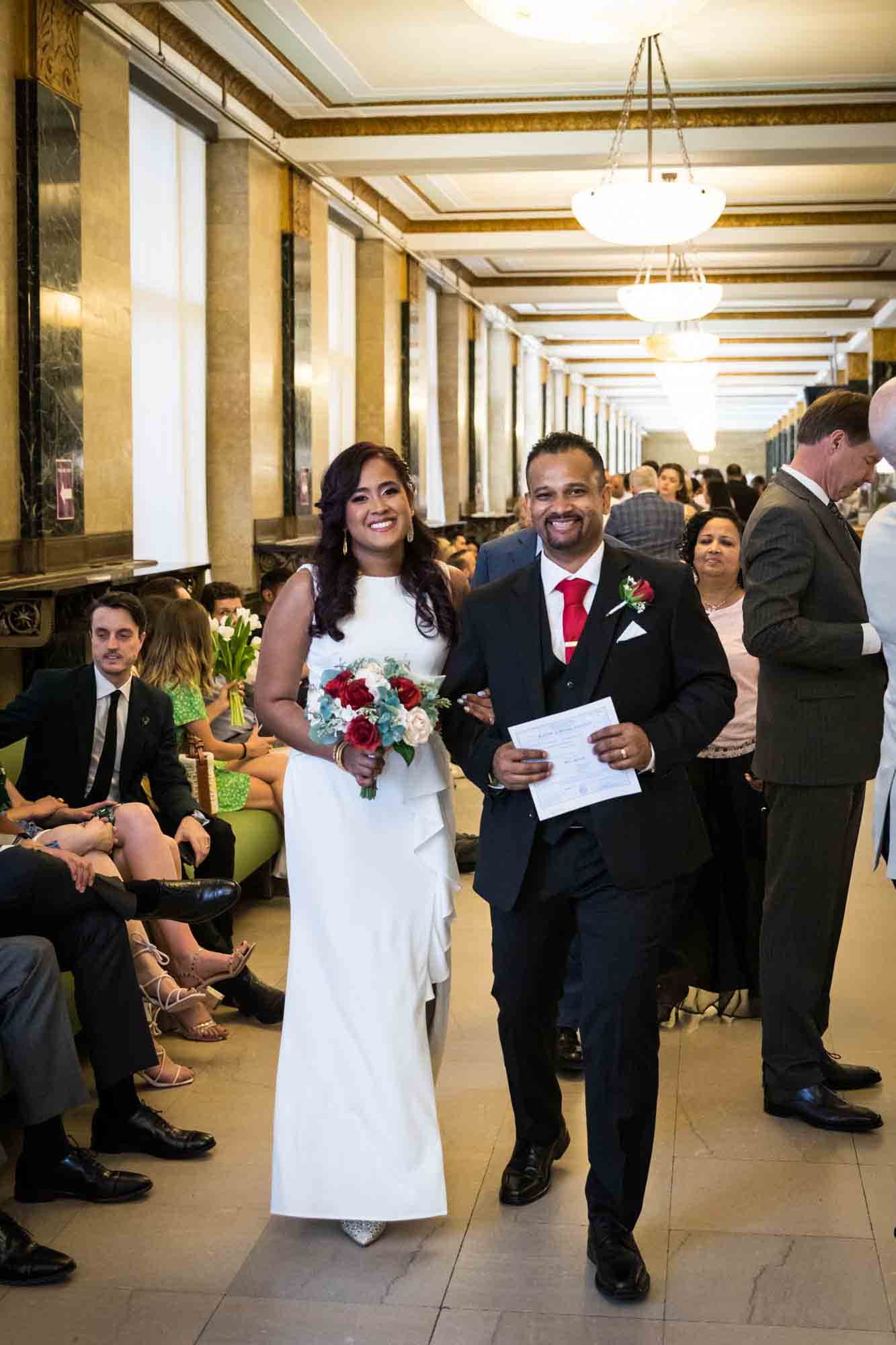 Couple walking out of City Clerk's office  at a NYC City Hall wedding