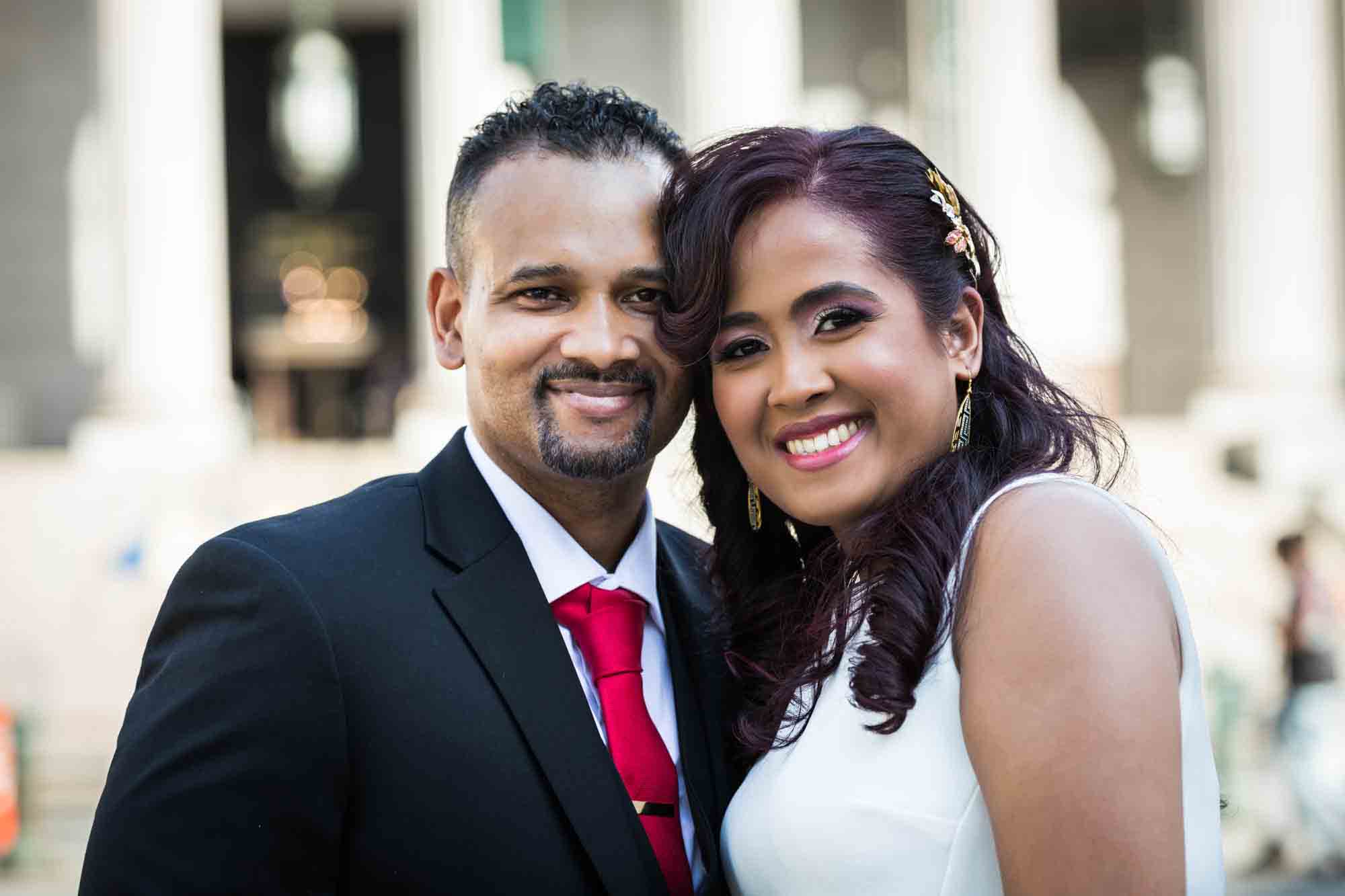 Bride and groom with heads together outdoors for an article on how to elope in NYC