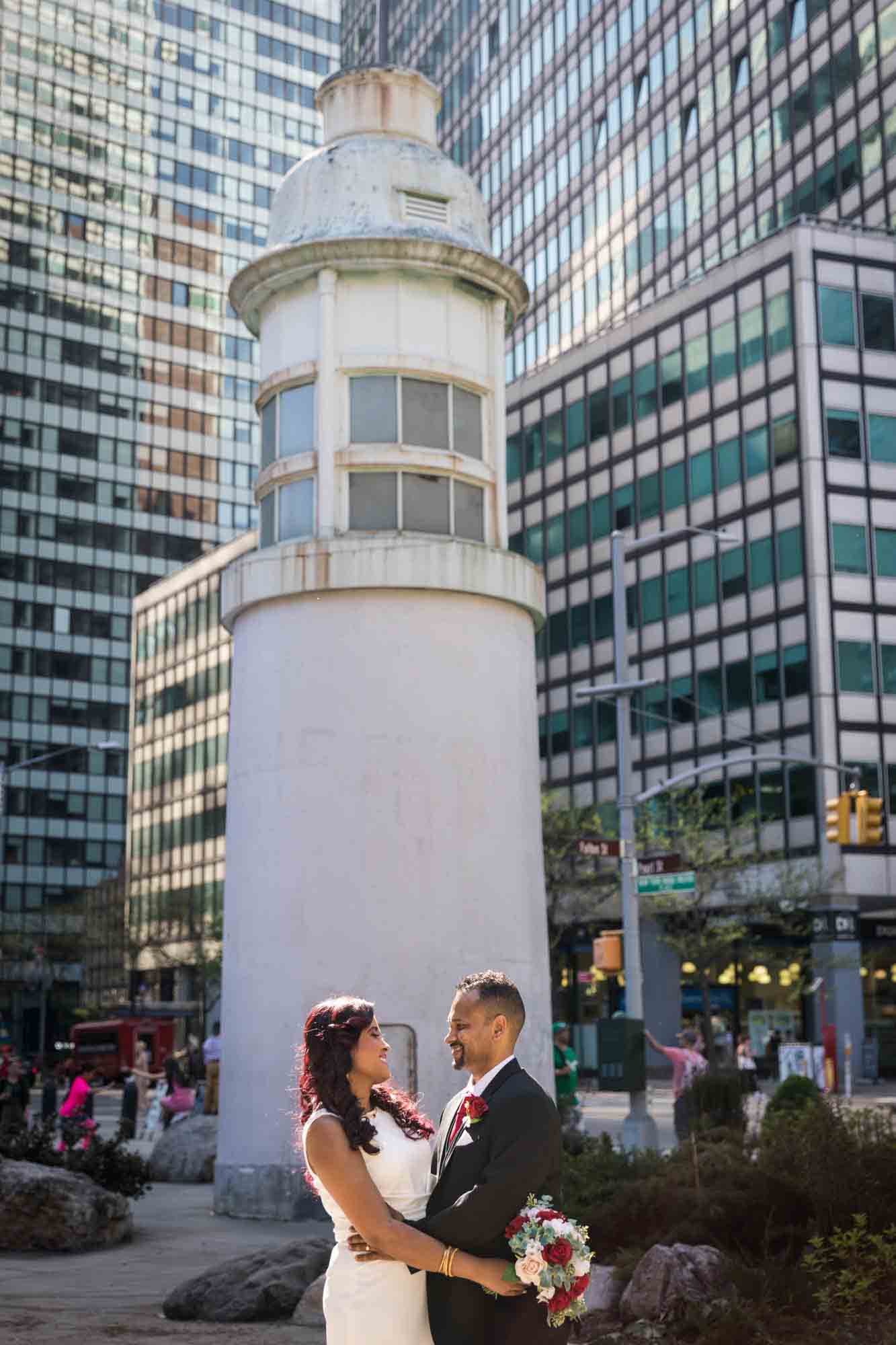 Bride and groom standing in front of lighthouse in South Street Seaport