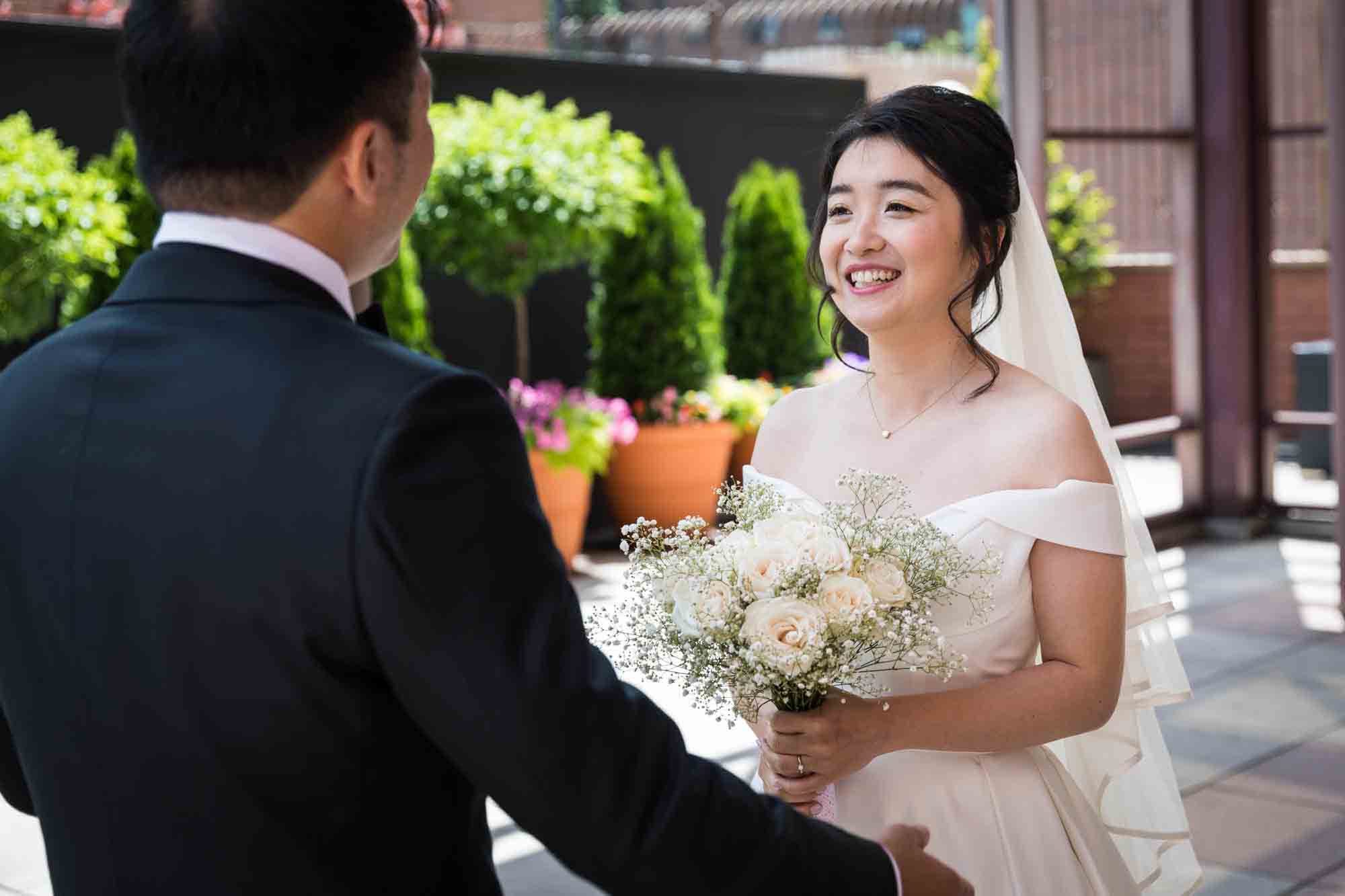 Bride smiling at groom during first look at a Sheraton LaGuardia East Hotel wedding