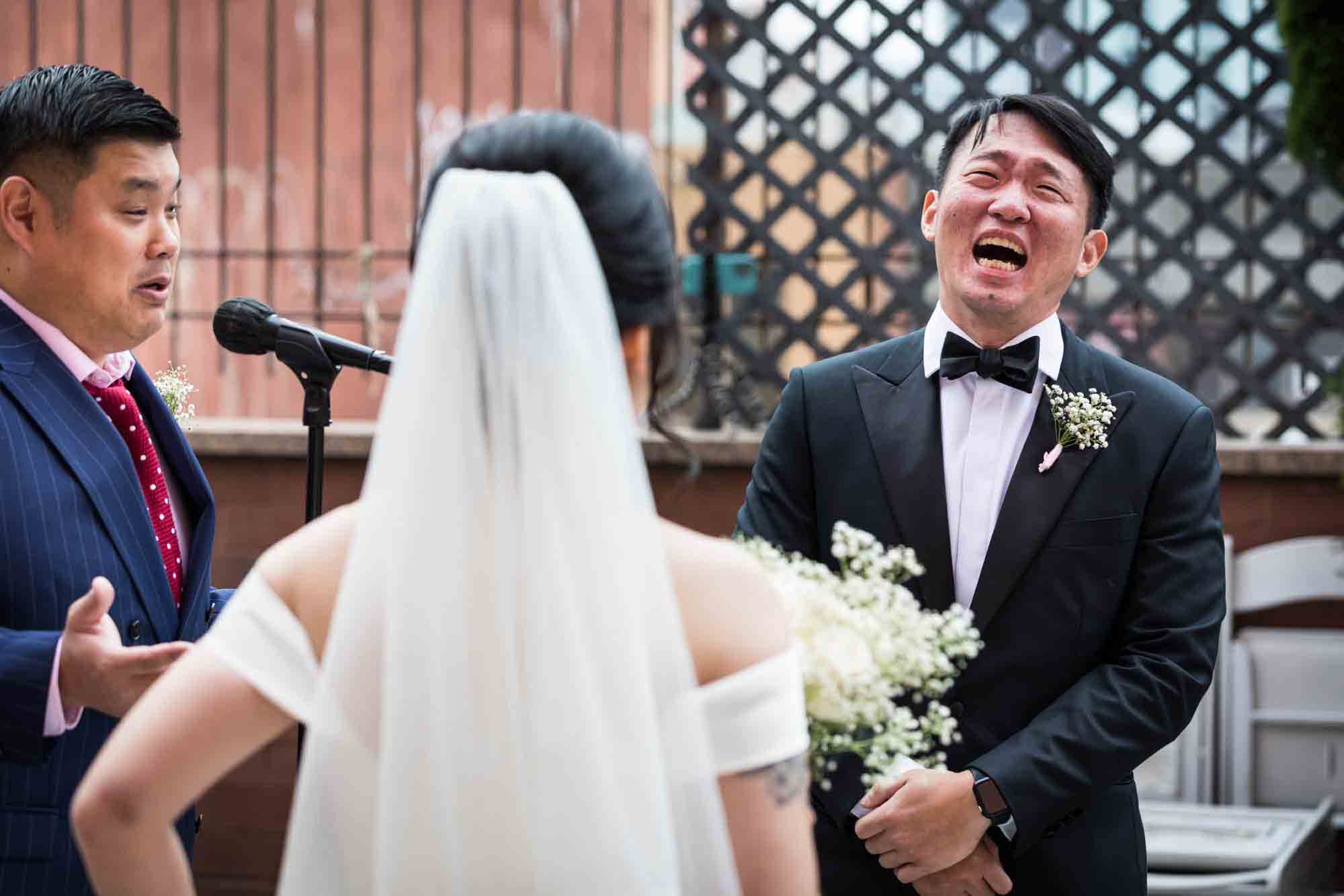 Groom laughing during ceremony at a Sheraton LaGuardia East Hotel wedding
