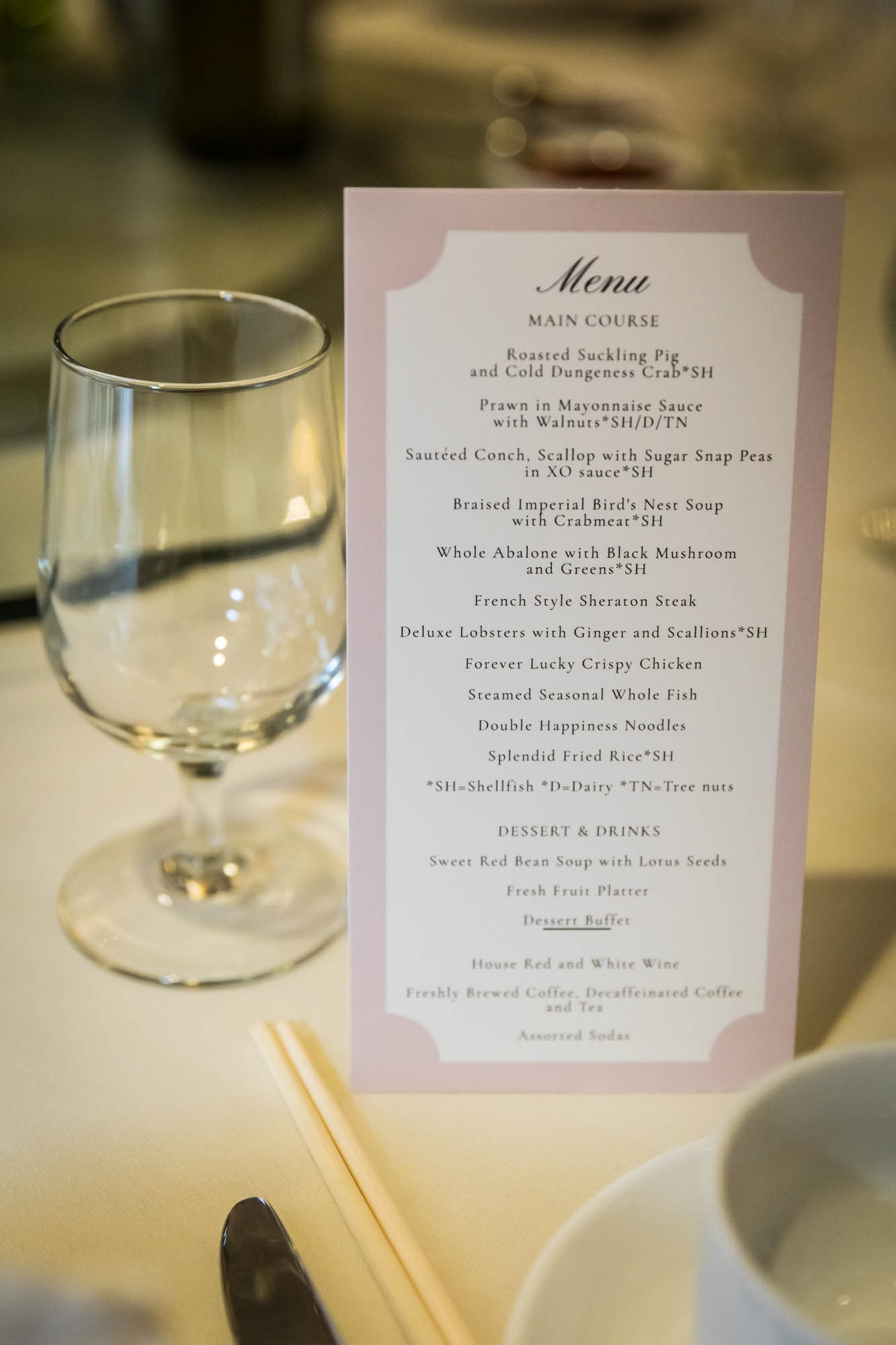 Empty wine glass next to menu card at a Sheraton LaGuardia East Hotel wedding
