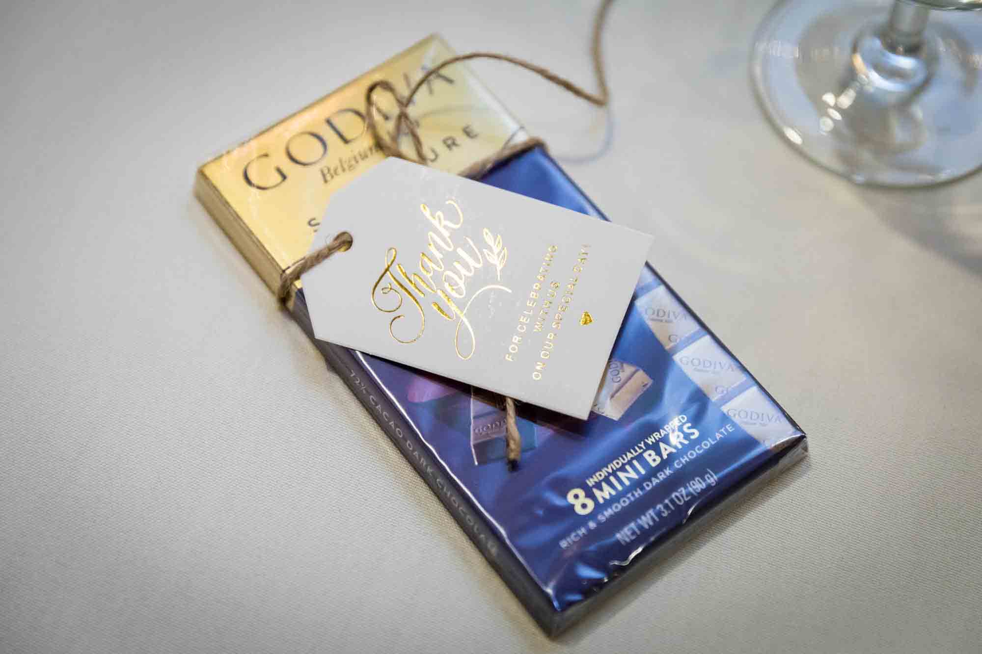 Godiva chocolate bar with white and gold tag at a Sheraton LaGuardia East Hotel wedding