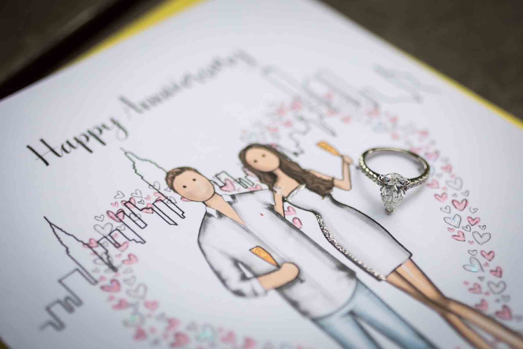 Card with cartoon couple and real engagement rings for an article on the best places to propose in Central Park 