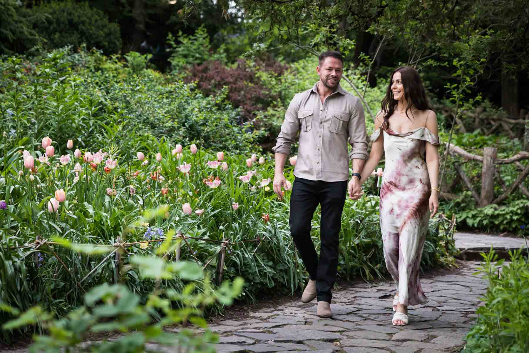 Couple walking in Shakespeare Garden for an article on the best places to propose in Central Park