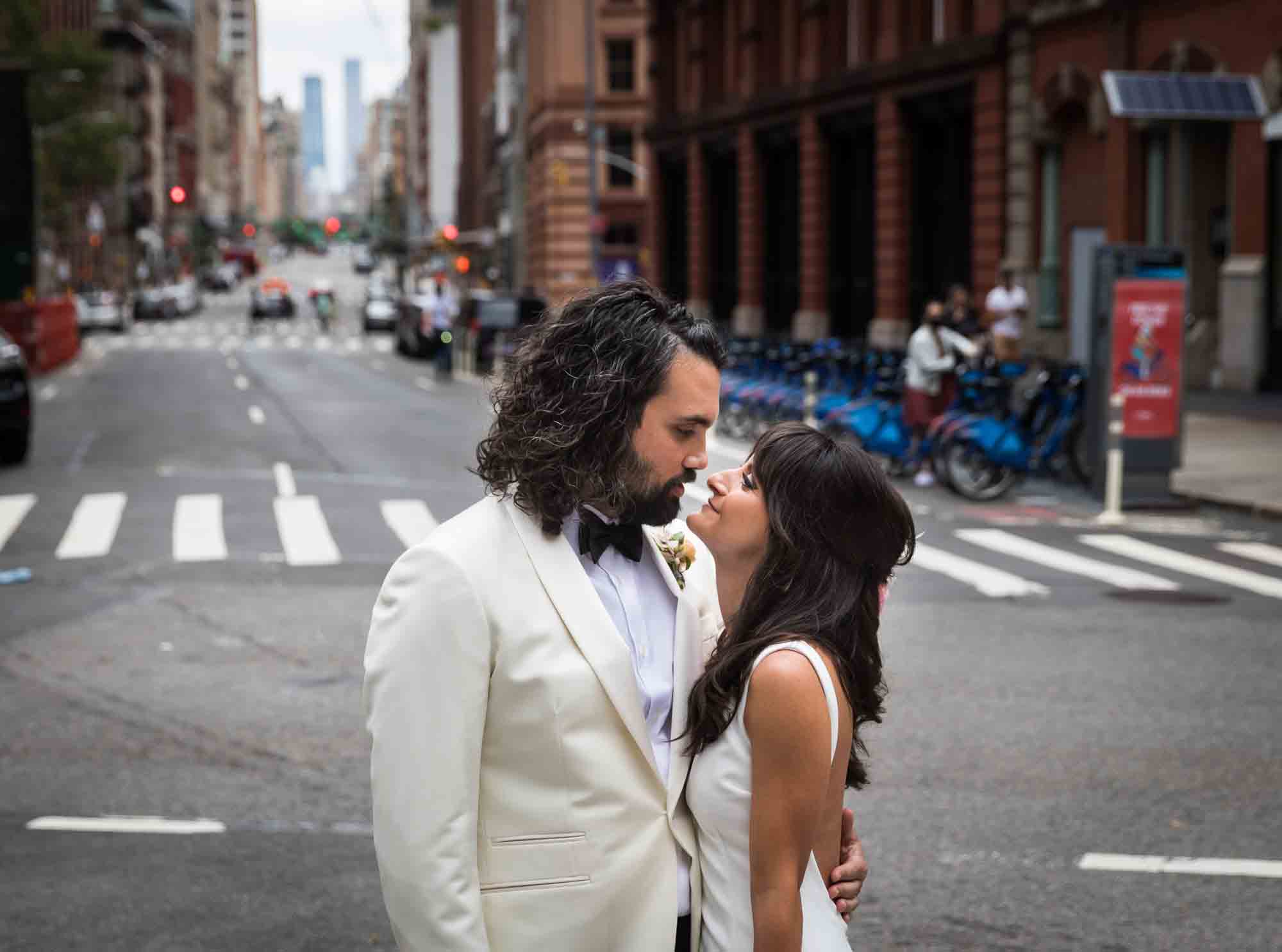 Bride and groom looking at each other in middle of NYC street