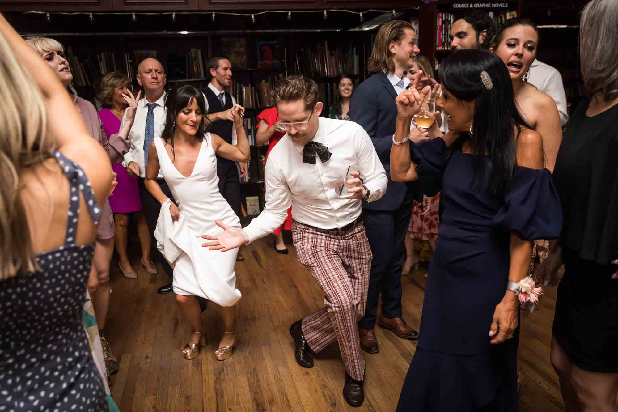 Bride dancing with guest wearing crazy pants at a Housing Works wedding