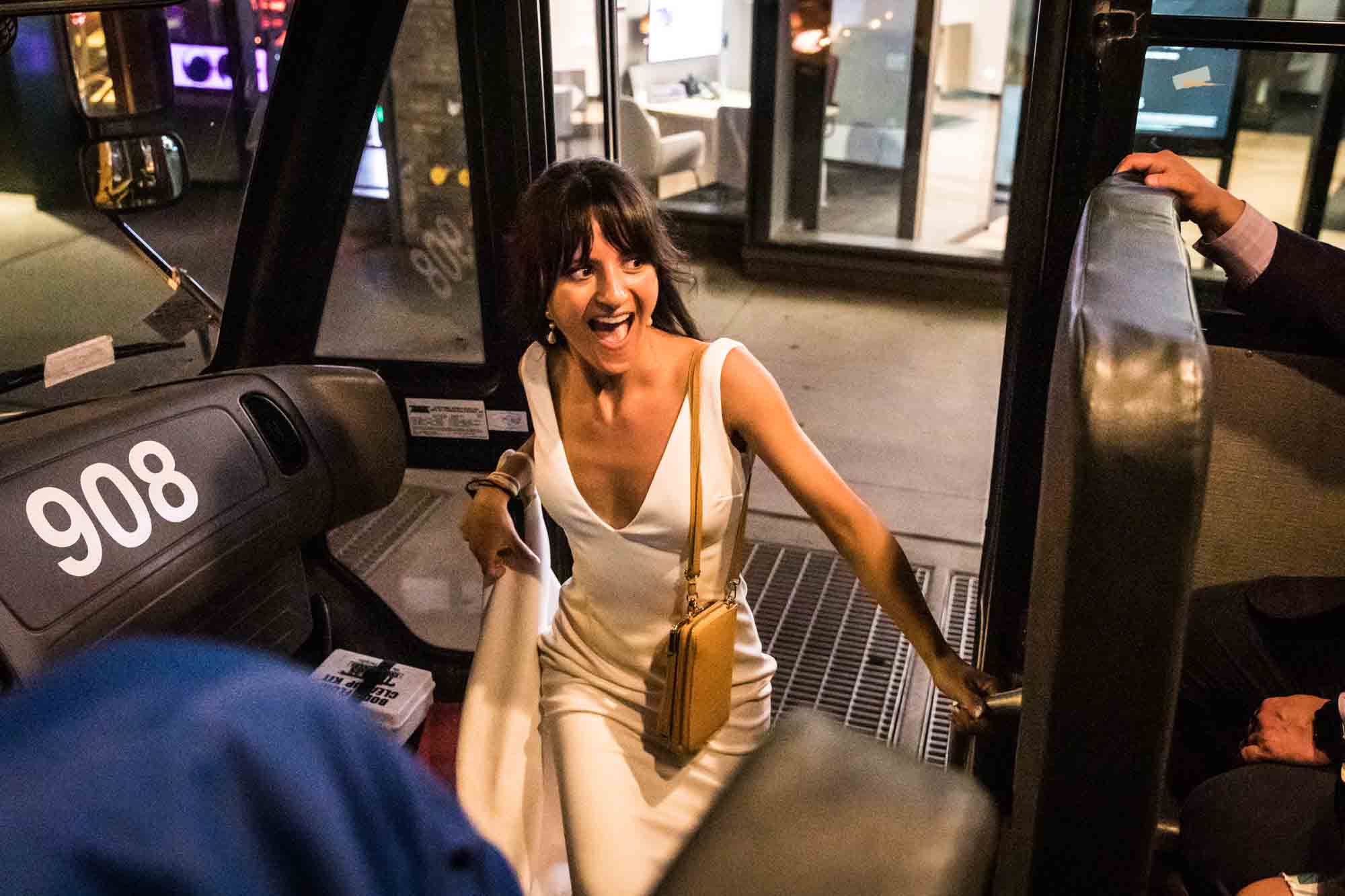 Bride walking up steps of school bus