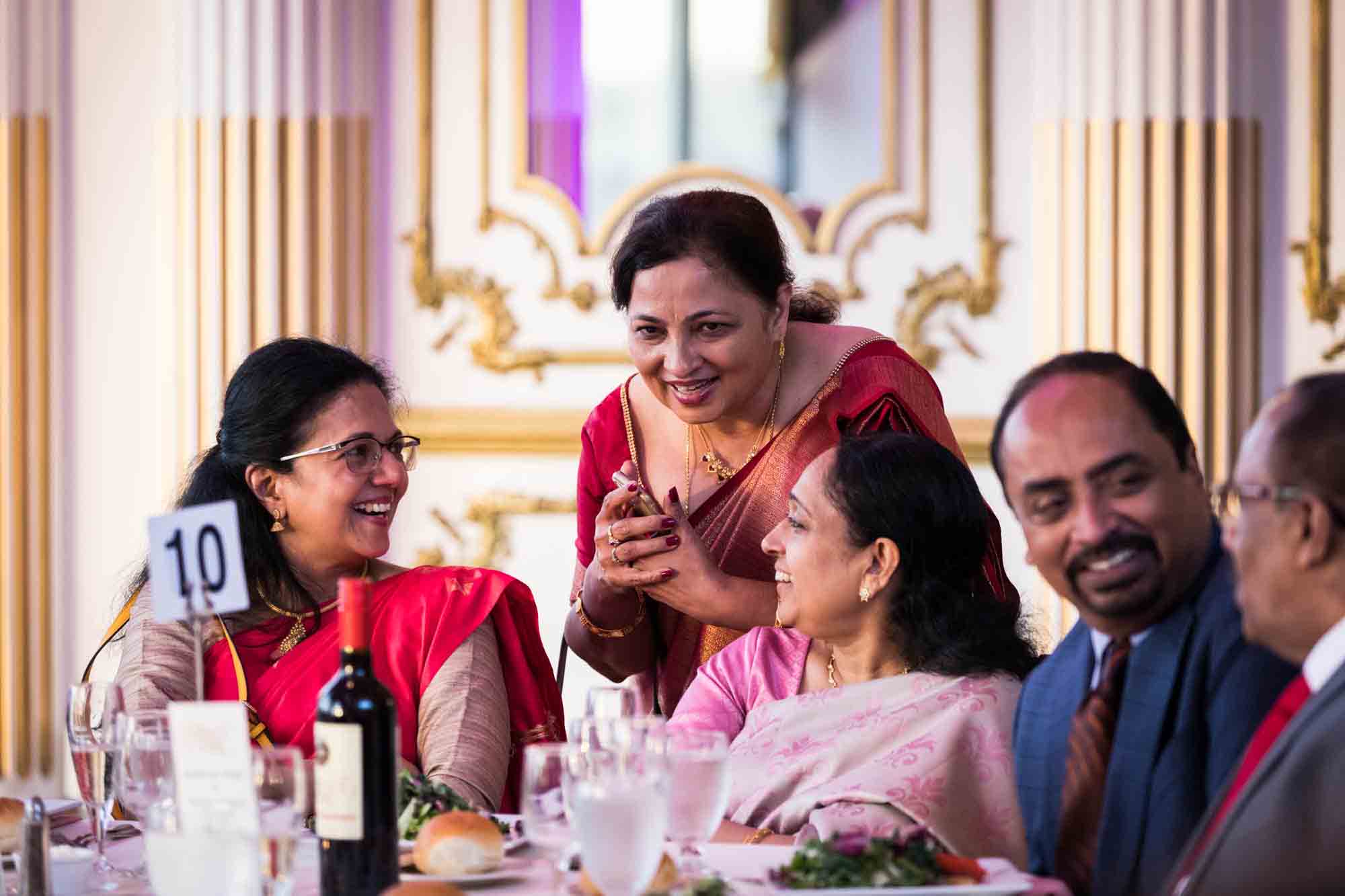 Indian guests chatting and laughing during a Terrace on the Park wedding