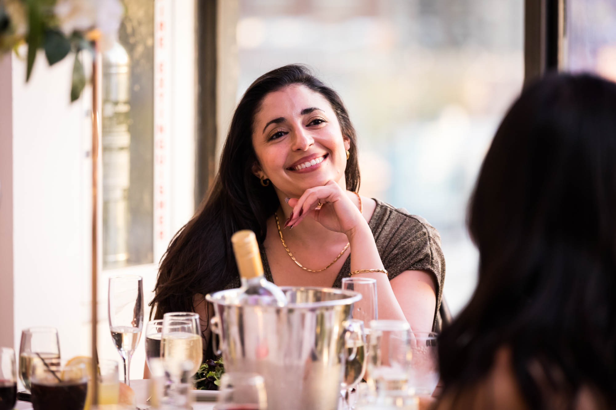 Woman resting chin on hand smiling during reception during a Terrace on the Park wedding