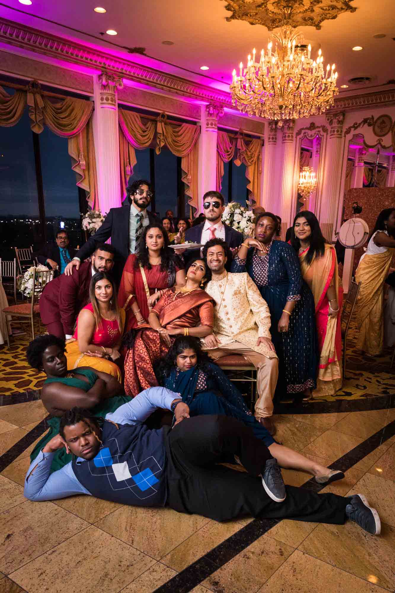 Guests posing with Indian bride and groom on dance floor during a Terrace on the Park wedding