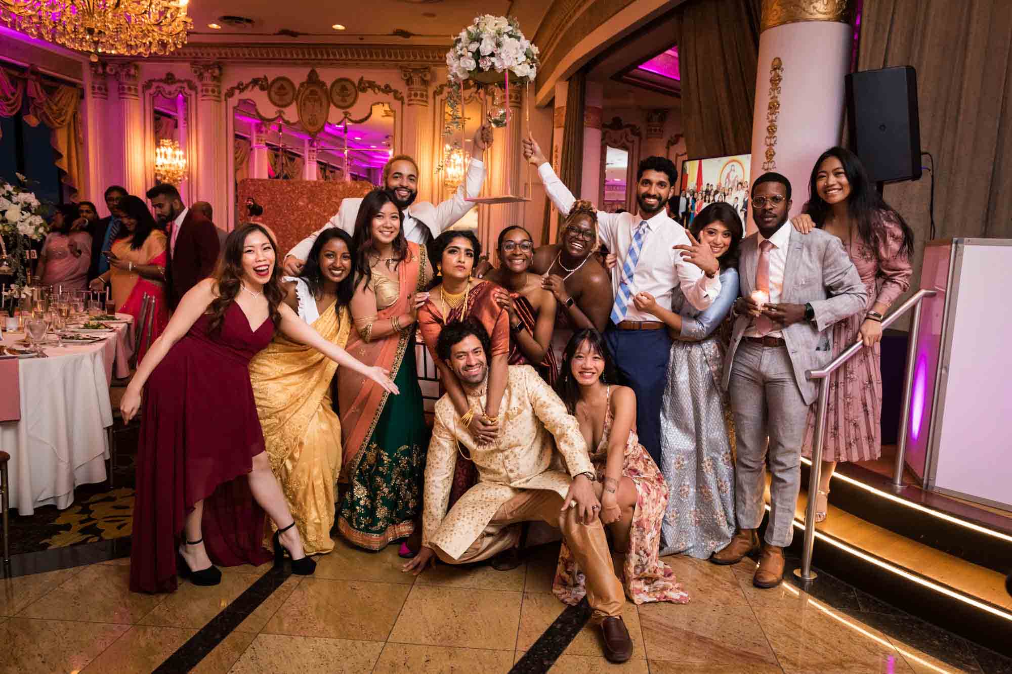 Guests posing with Indian bride and groom on dance floor during a Terrace on the Park wedding