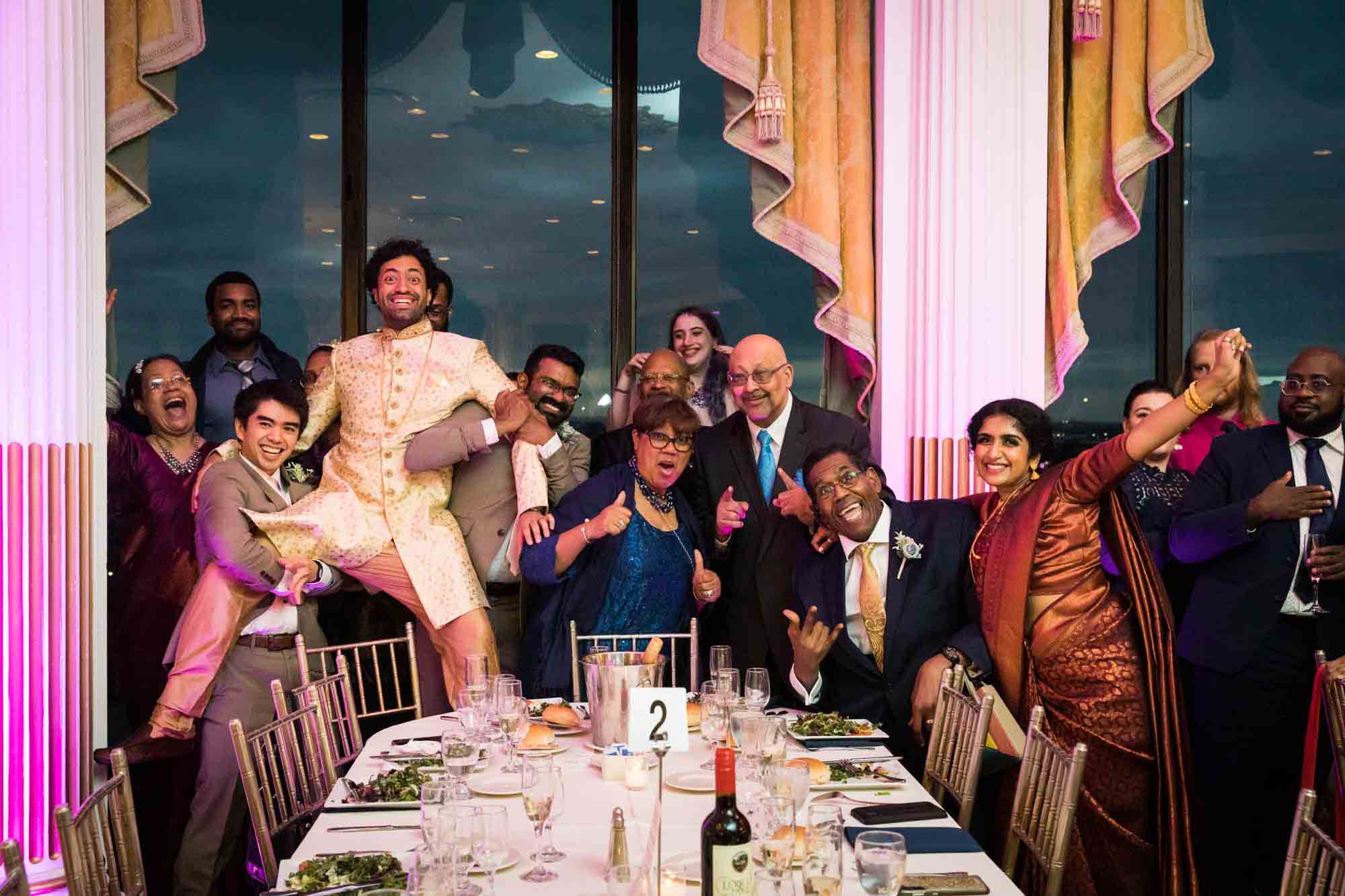 Guests posing with Indian bride and groom during a Terrace on the Park wedding