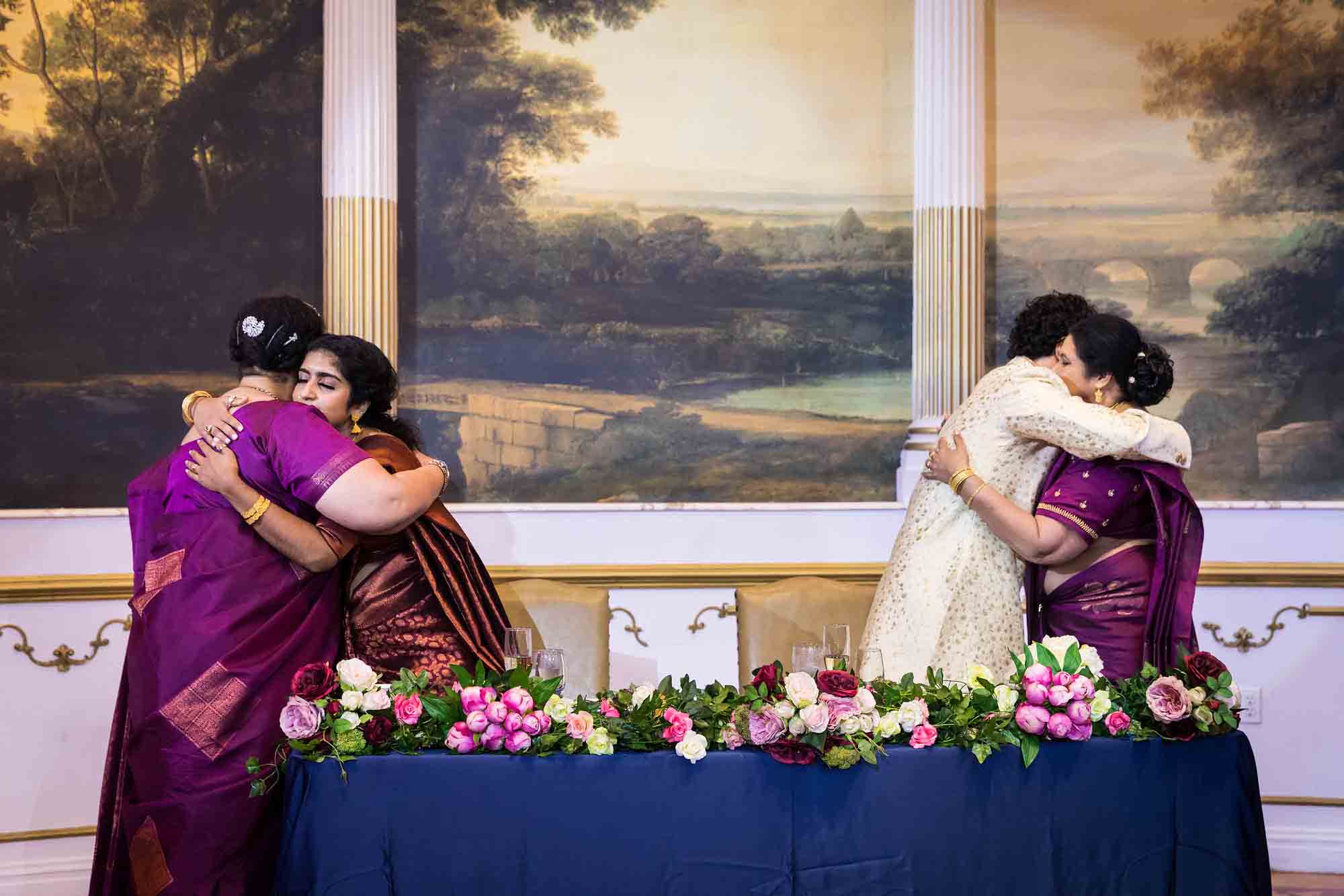 Bride hugging mother and groom hugging mother during milk ceremony during a Terrace on the Park wedding